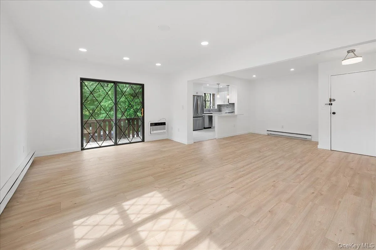 Living room opens to dining area and kitchen. Living room opens to dining area and kitchen.