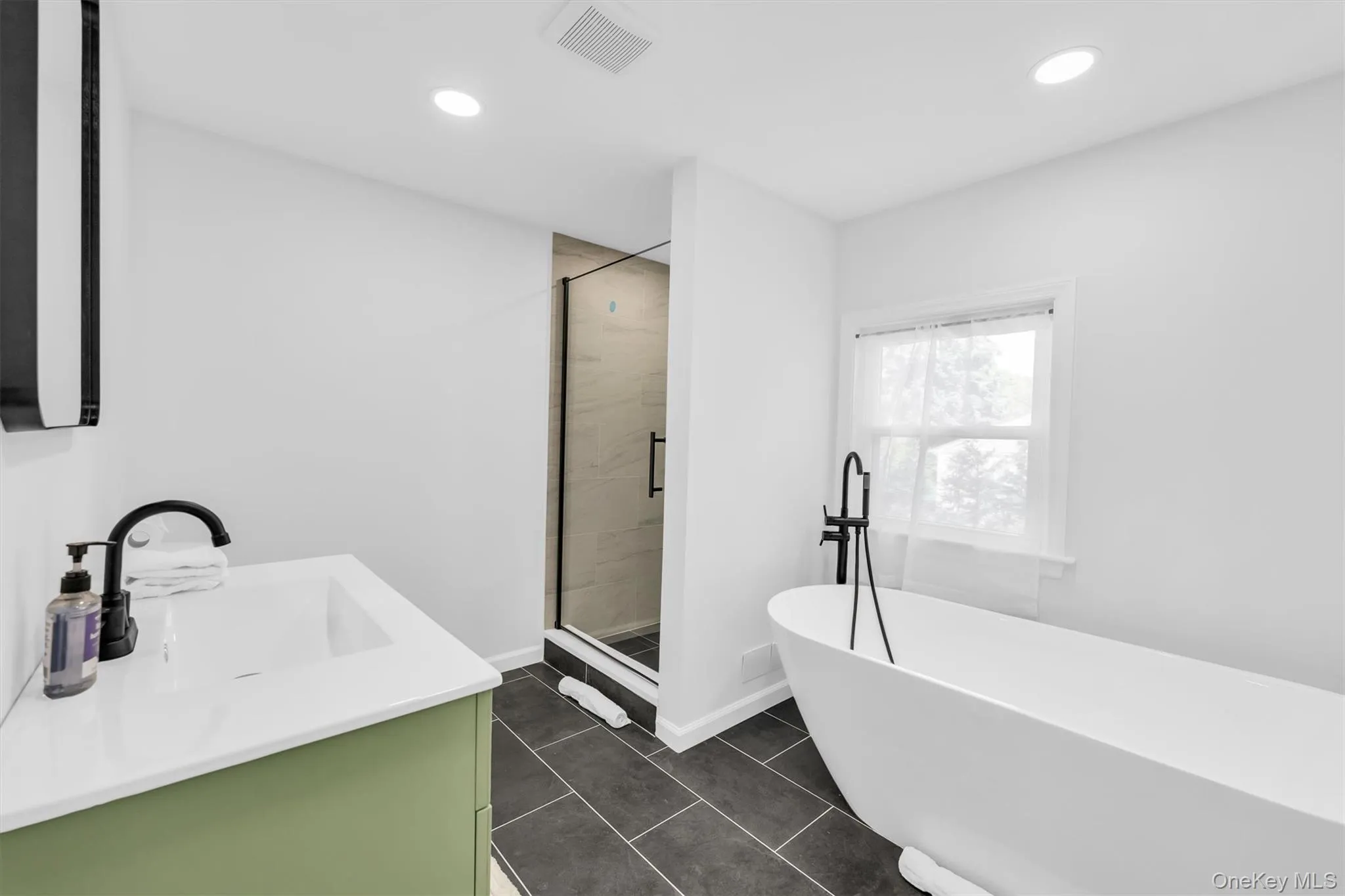 primary bathroom with stand free bathtub and shower primary bathroom with stand free bathtub and shower