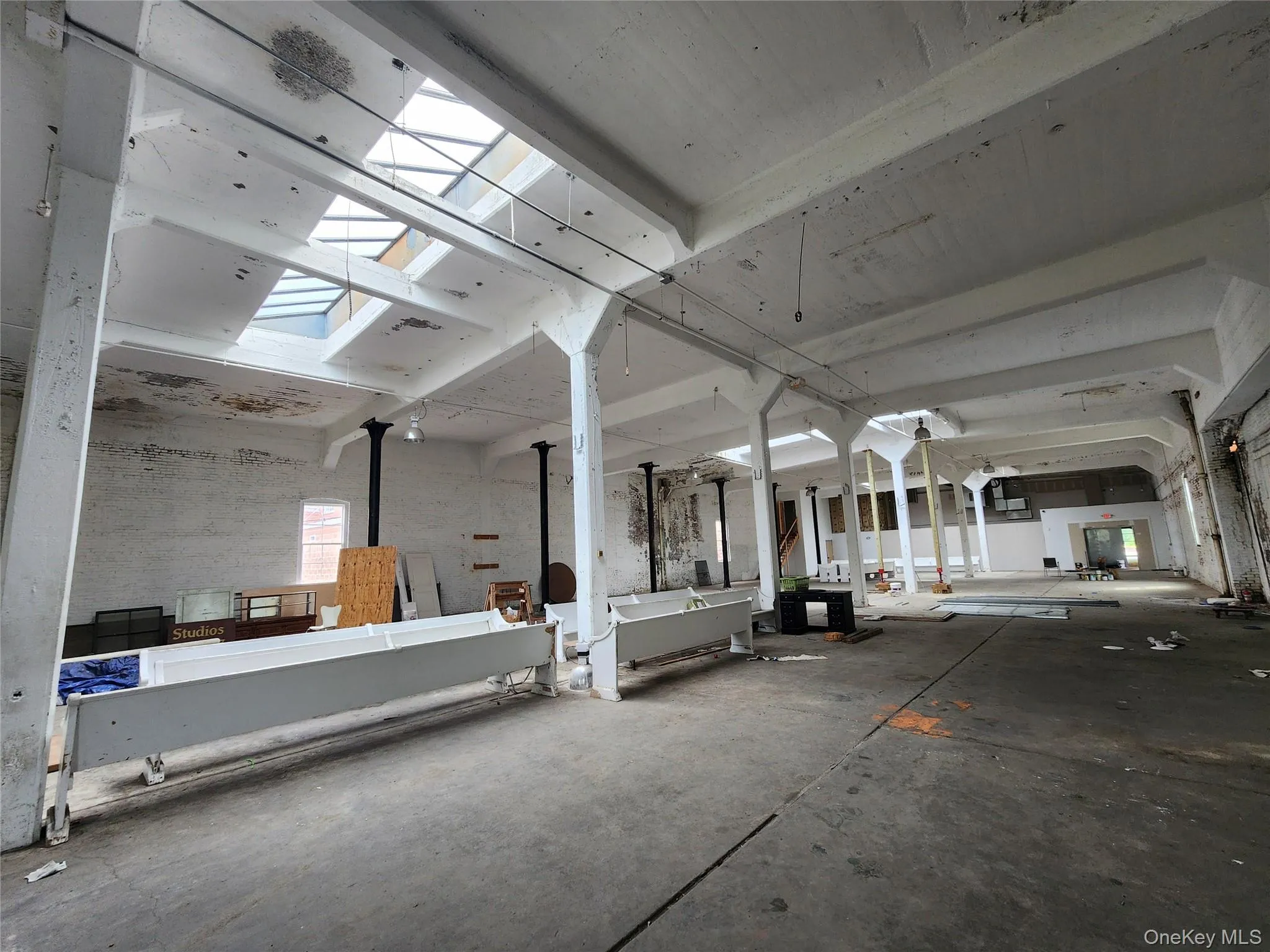 Miscellaneous room featuring a skylight and concrete floors Miscellaneous room featuring a skylight and concrete floors