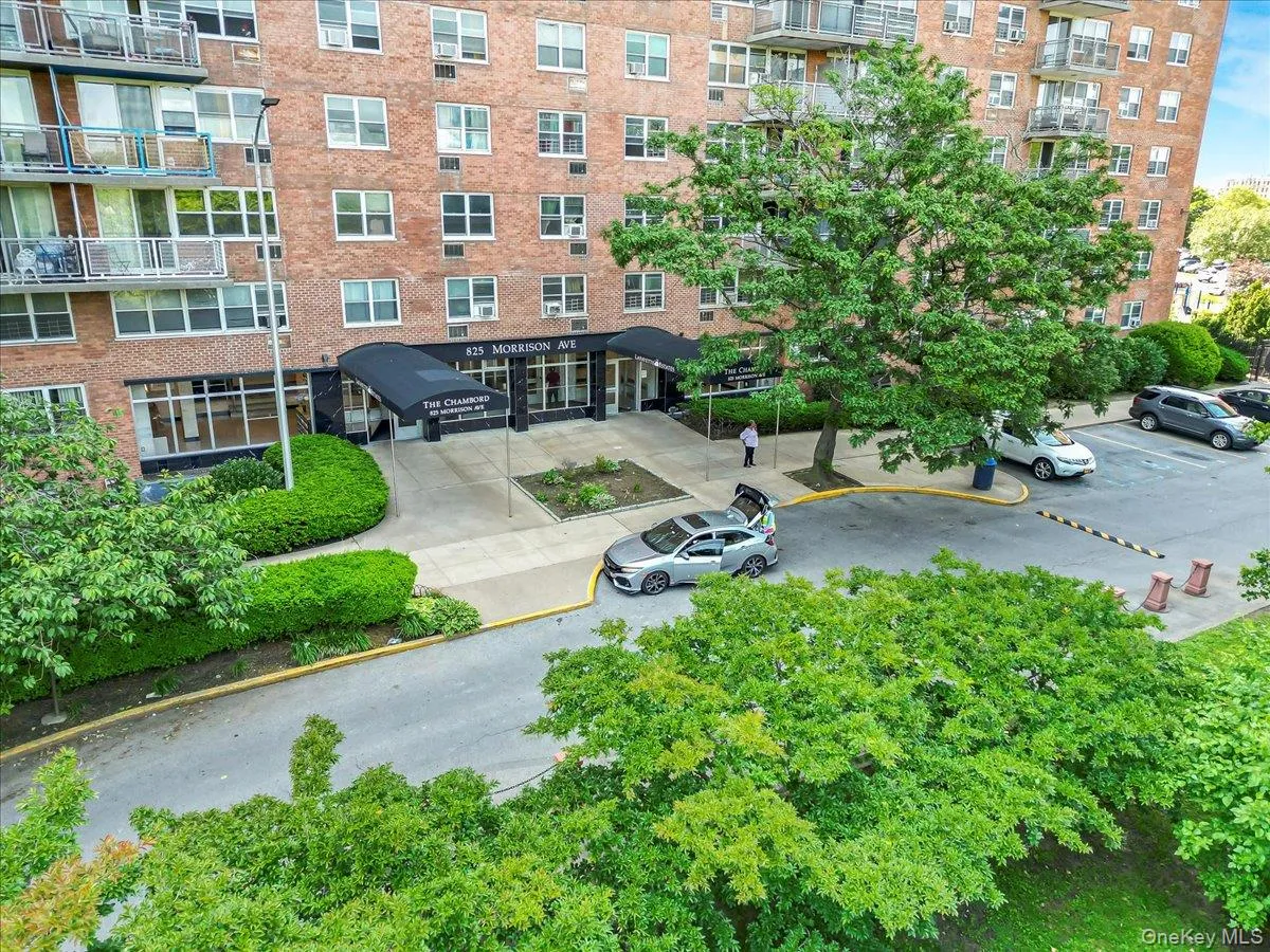 View of apartment building / complex featuring uncovered parking View of apartment building / complex featuring uncovered parking