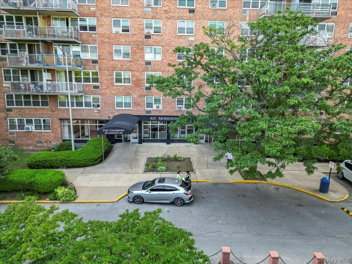 View of apartment building / complex with uncovered parking View of apartment building / complex with uncovered parking