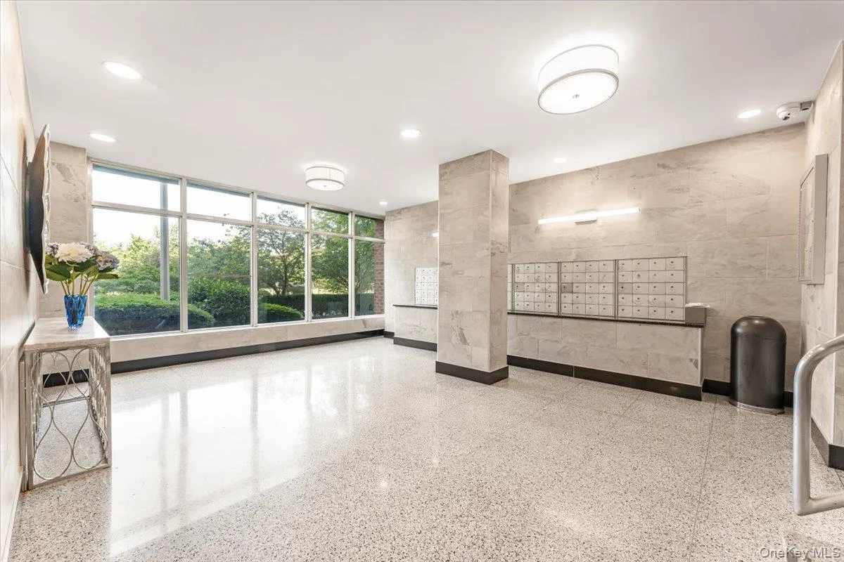 Building lobby featuring floor to ceiling windows and recessed lighting Building lobby featuring floor to ceiling windows and recessed lighting