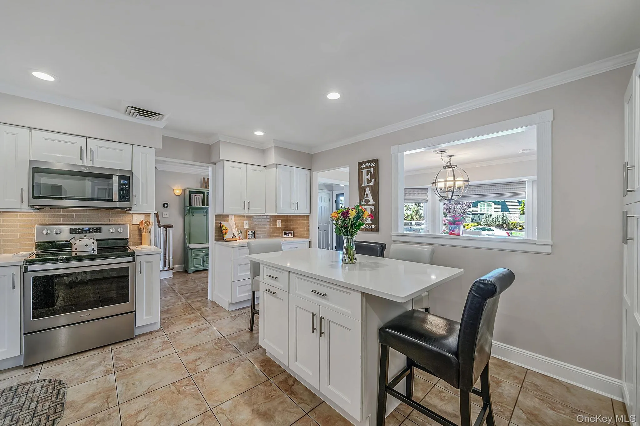 Spacious and Updated EIK with White Shaker Cabinetry, Quartz Countertops, SS Appliances, Pantry, Butler Pantry with Beverage Fridge, Recessed Lighting, Crown Molding Spacious and Updated EIK with White Shaker Cabinetry, Quartz Countertops, SS Appliances, Pantry, Butler Pantry with Beverage Fridge, Recessed Lighting, Crown Molding