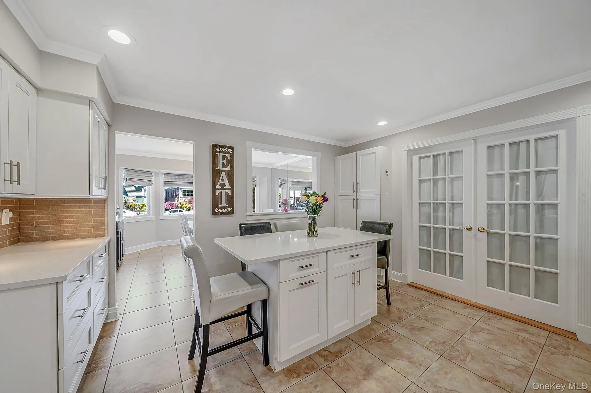 Spacious and Updated EIK with White Shaker Cabinetry, Quartz Countertops, SS Appliances, Pantry, Butler Pantry with Beverage Fridge, Recessed Lighting, Crown Molding Spacious and Updated EIK with White Shaker Cabinetry, Quartz Countertops, SS Appliances, Pantry, Butler Pantry with Beverage Fridge, Recessed Lighting, Crown Molding