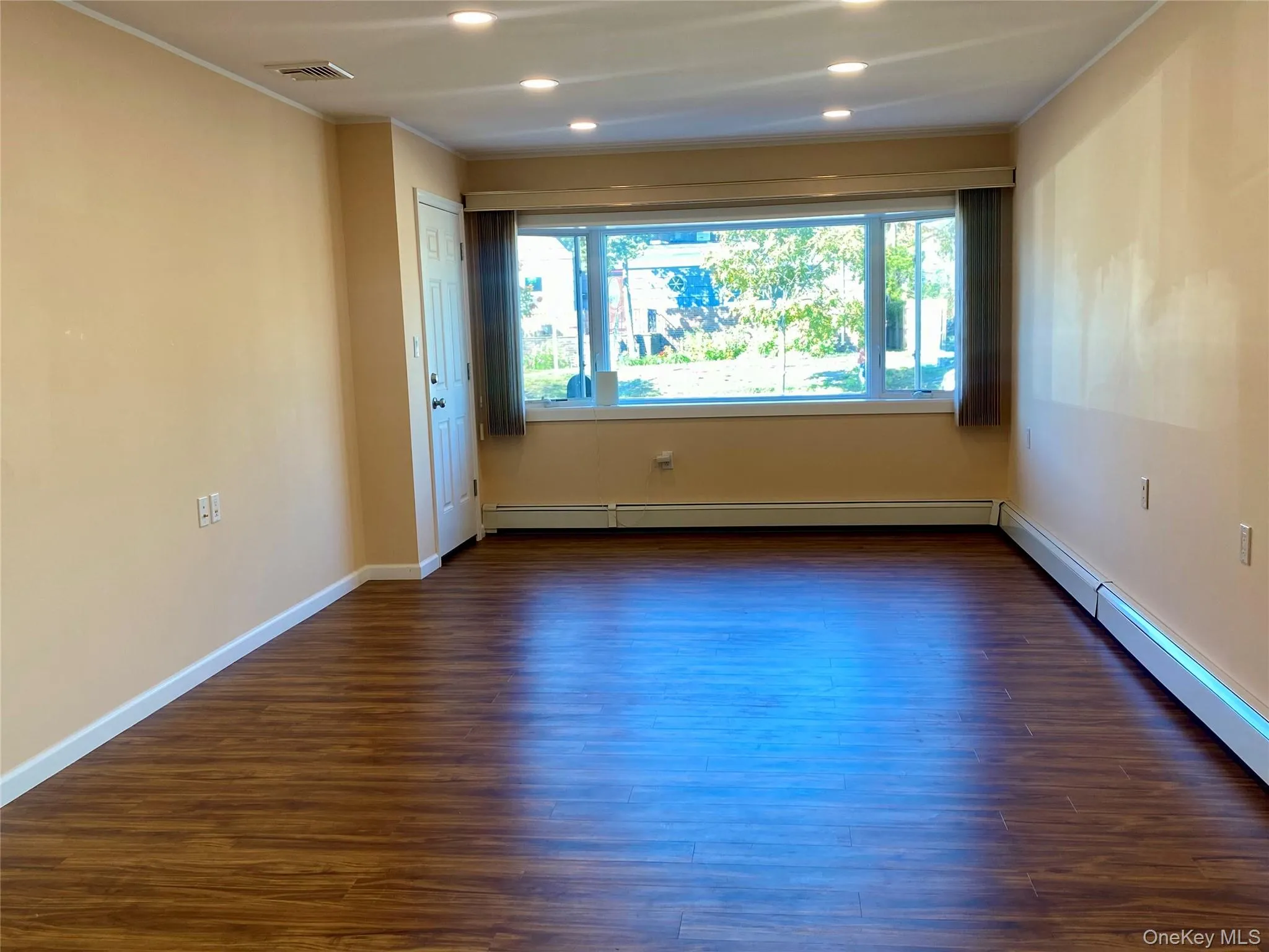 Spacious Living Room Facing from Kitchen to Front Windows Spacious Living Room Facing from Kitchen to Front Windows