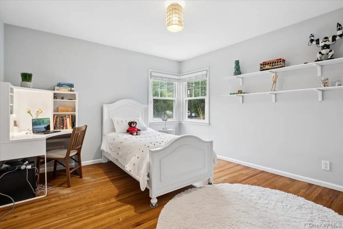 Light-filled room featuring wood flooring and two exposures. Light-filled room featuring wood flooring and two exposures.