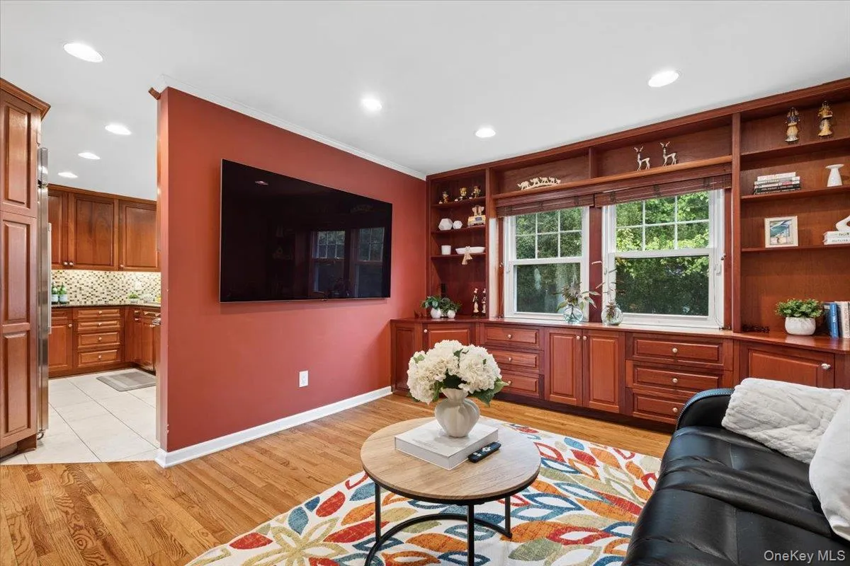 Family living area with extensive built-in cabinetry featuring plenty of open shelving and drawer storage. Family living area with extensive built-in cabinetry featuring plenty of open shelving and drawer storage.