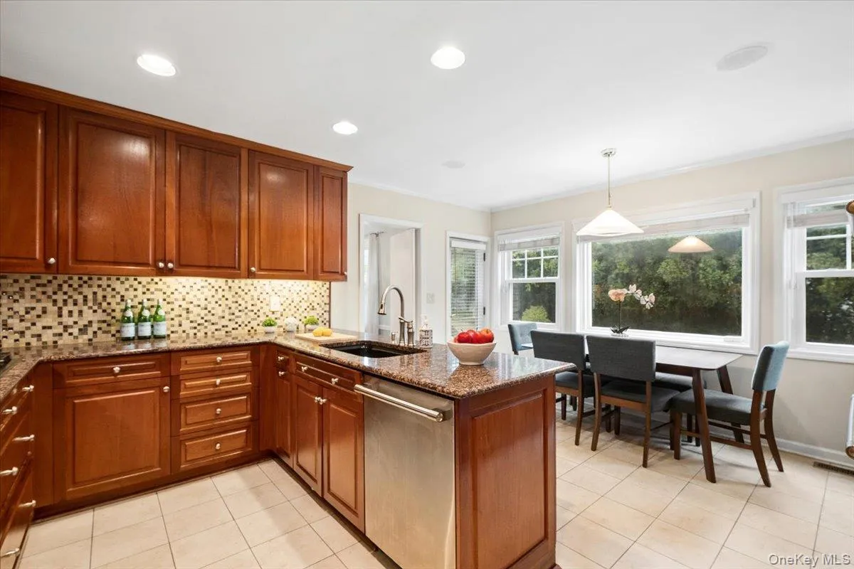 Eat-in area of kitchen with sunny views of lush backyard. Eat-in area of kitchen with sunny views of lush backyard.