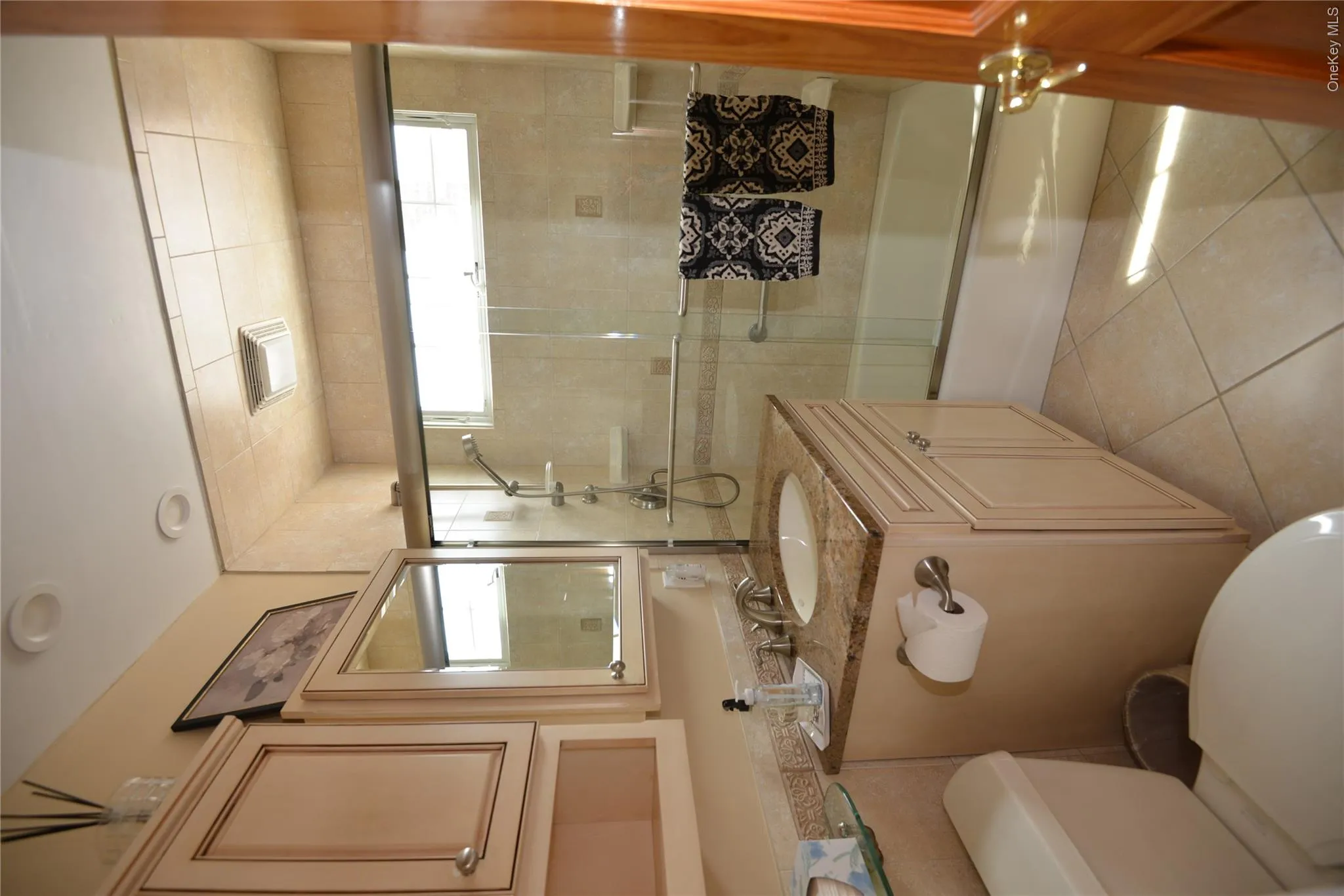 Bathroom featuring a single vanity with a granite countertop, undermount sink, and polished chrome faucet Bathroom featuring a single vanity with a granite countertop, undermount sink, and polished chrome faucet