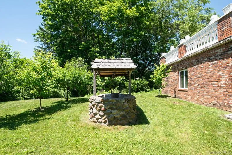Stone Wishing Well with Fruit Trees. Stone Wishing Well with Fruit Trees.