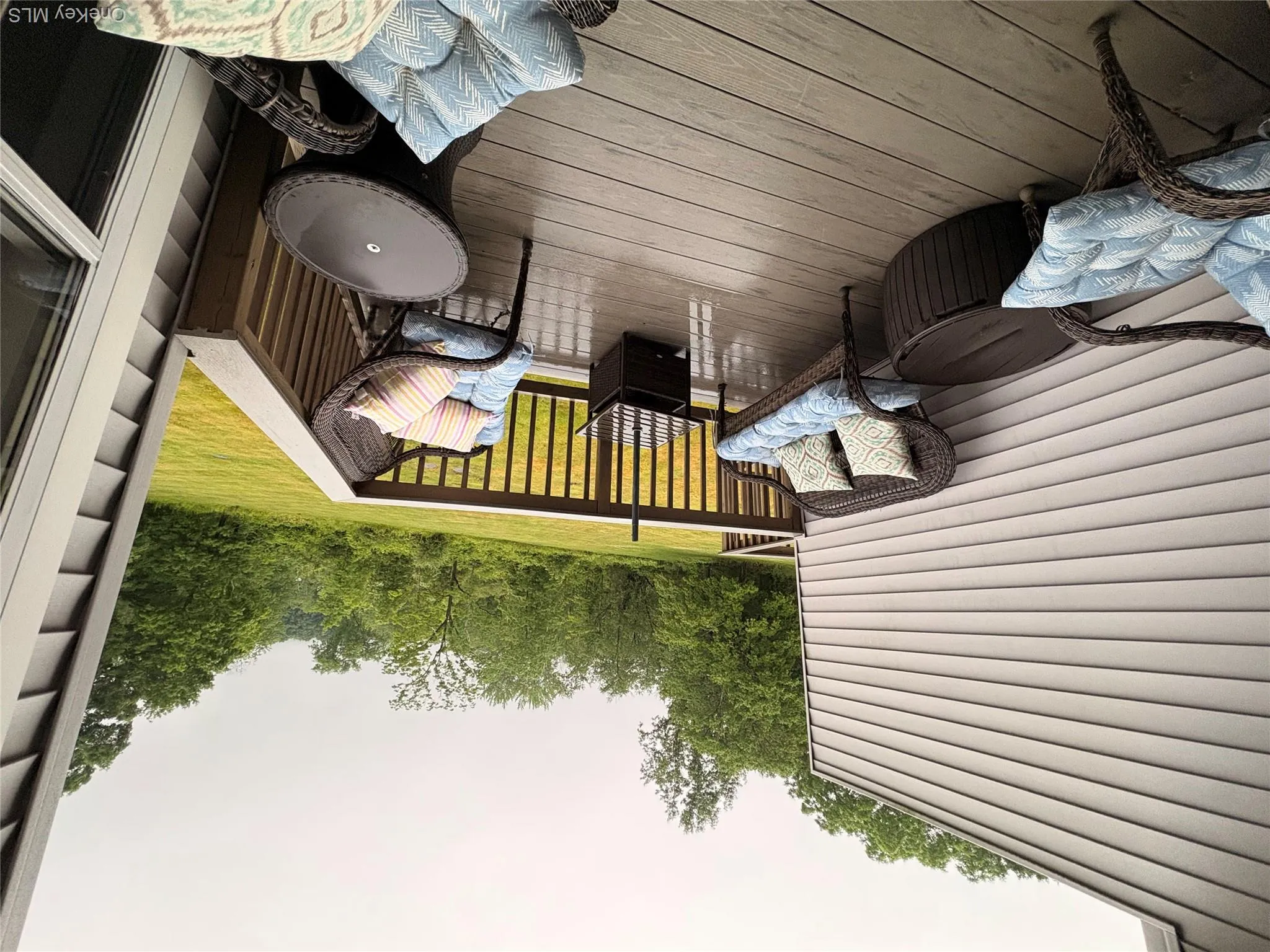 Spacious outdoor deck with composite decking and wood railings Spacious outdoor deck with composite decking and wood railings