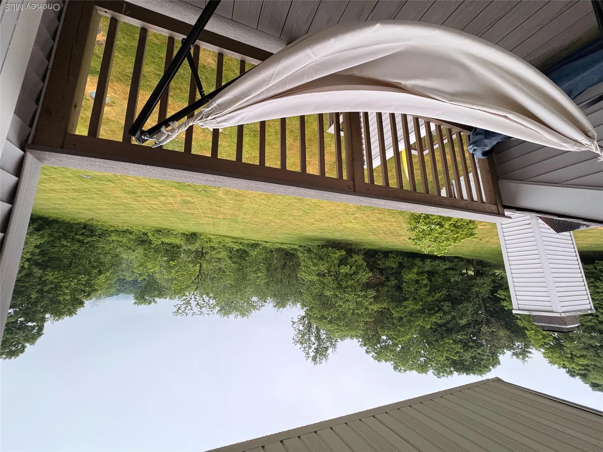 Covered porch featuring wood railing and deck flooring Covered porch featuring wood railing and deck flooring