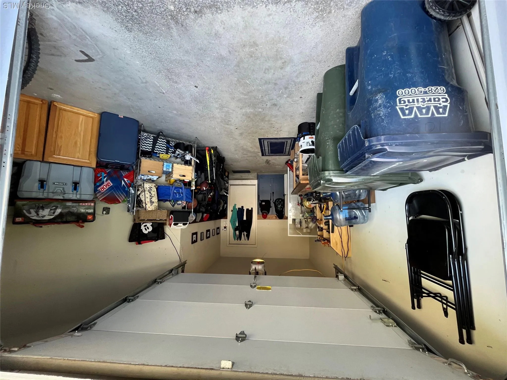 Attached garage with concrete flooring and a built-in workbench Attached garage with concrete flooring and a built-in workbench