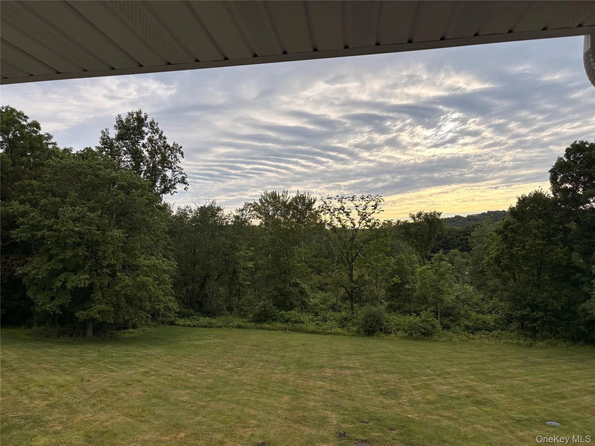 Expansive green lawn providing a substantial outdoor area Expansive green lawn providing a substantial outdoor area