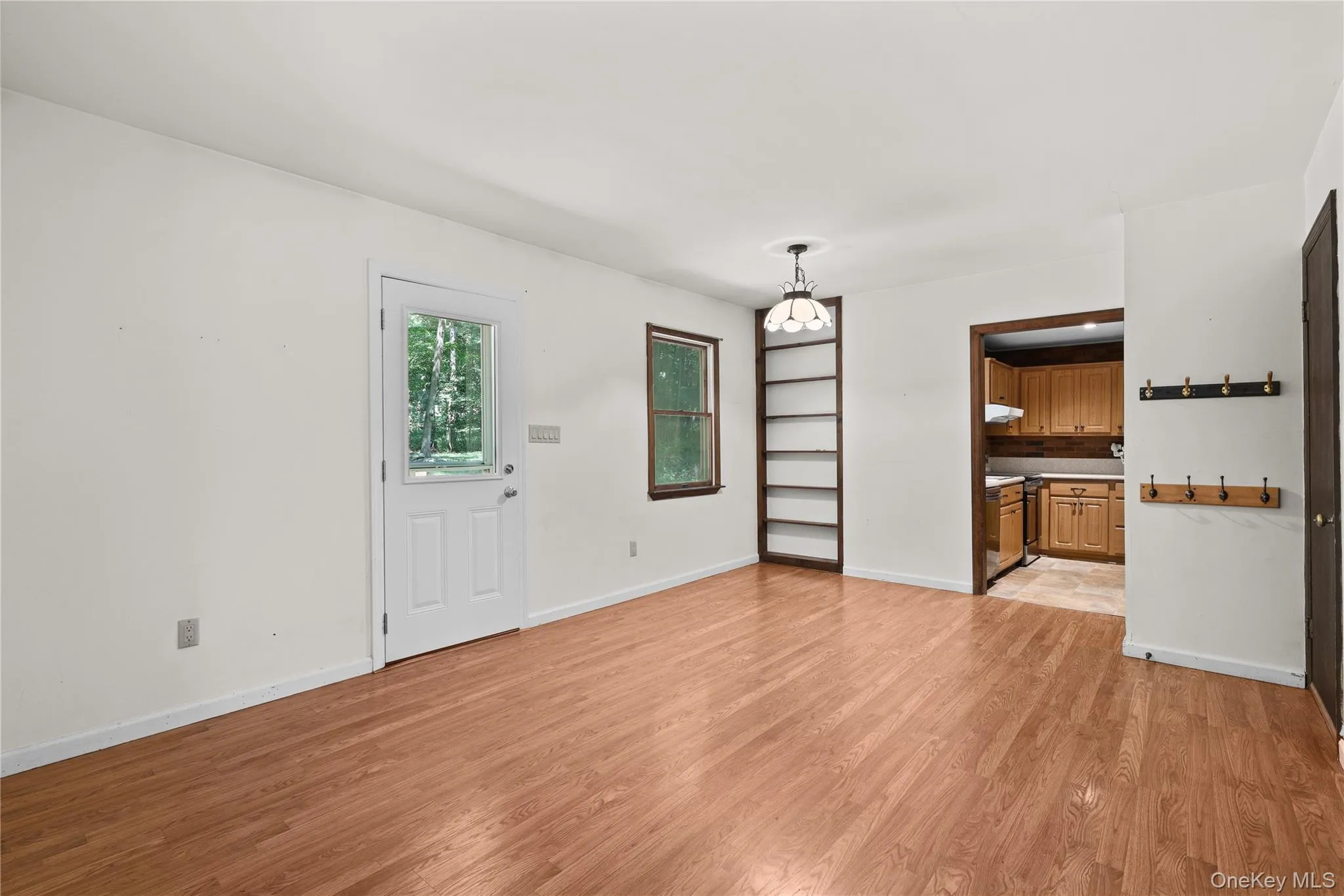 Dining area with door to back deck. Dining area with door to back deck.