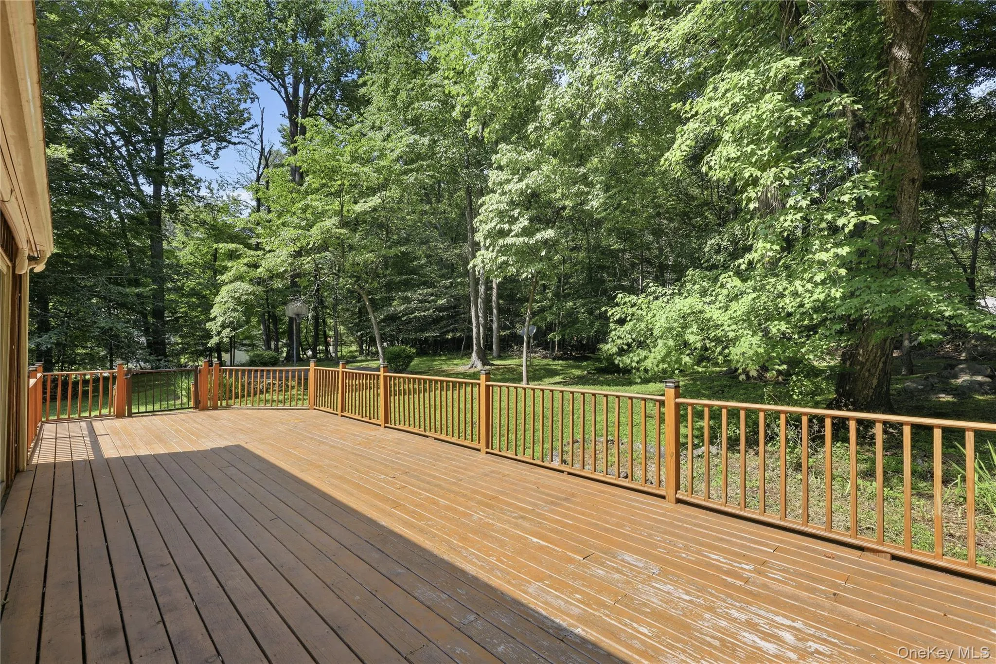 Large rear deck with ball court in background. Large rear deck with ball court in background.