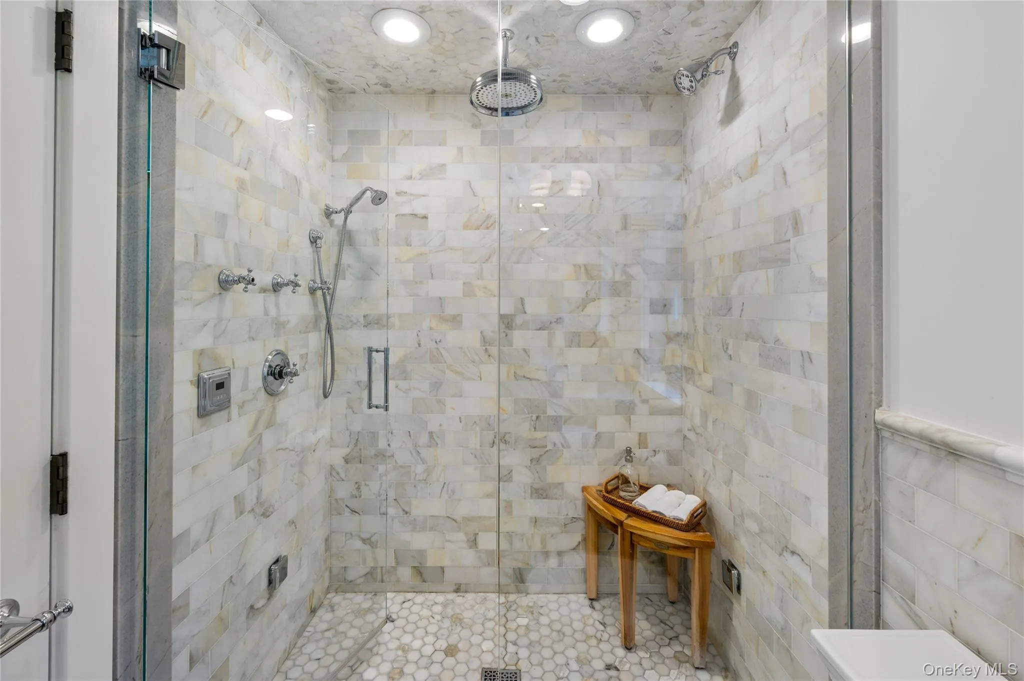 A spacious steam and rain shower complete this luxe primary bath. A spacious steam and rain shower complete this luxe primary bath.