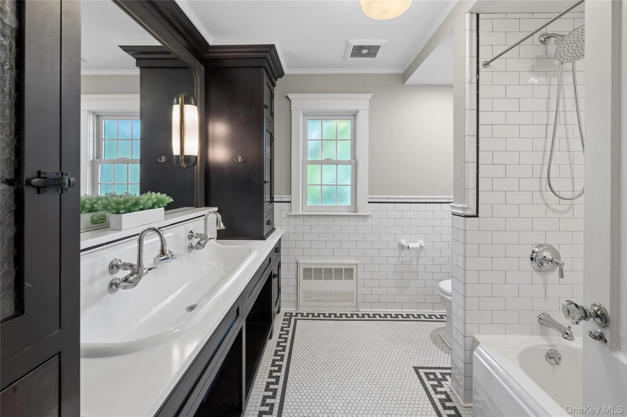 Shared hall bath on the second floor features a double sink and radiant heat custom tile floors. Shared hall bath on the second floor features a double sink and radiant heat custom tile floors.