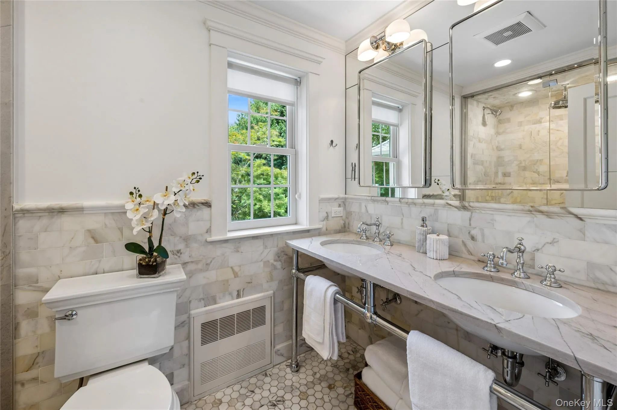 Calcutta marble, double sinks, radiant heated floor and recessed medicine cabinets. Calcutta marble, double sinks, radiant heated floor and recessed medicine cabinets.