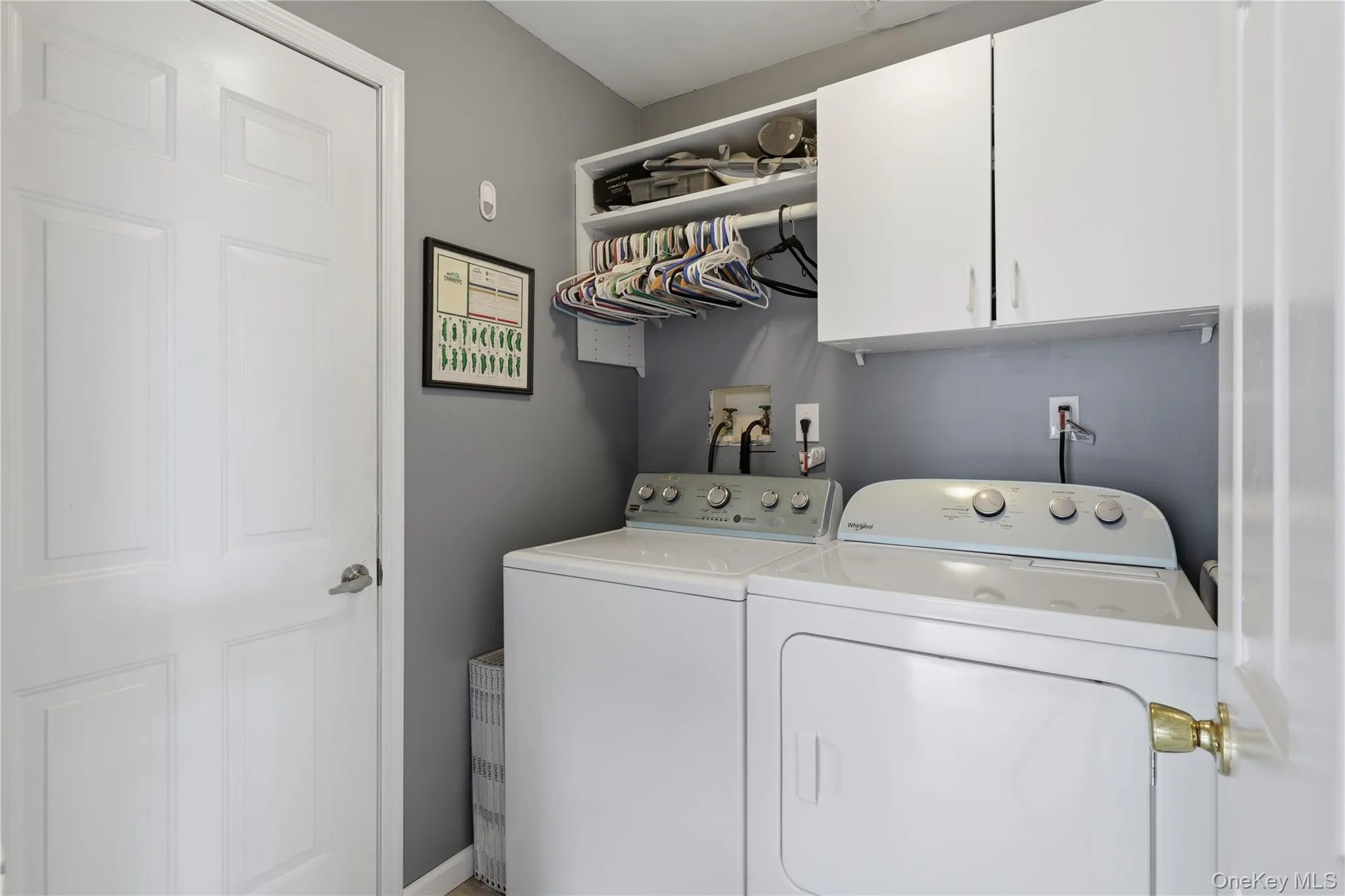 Dedicated utility area featuring a washer and new dryer, upper cabinetry, an open shelving unit with hanger space Dedicated utility area featuring a washer and new dryer, upper cabinetry, an open shelving unit with hanger space