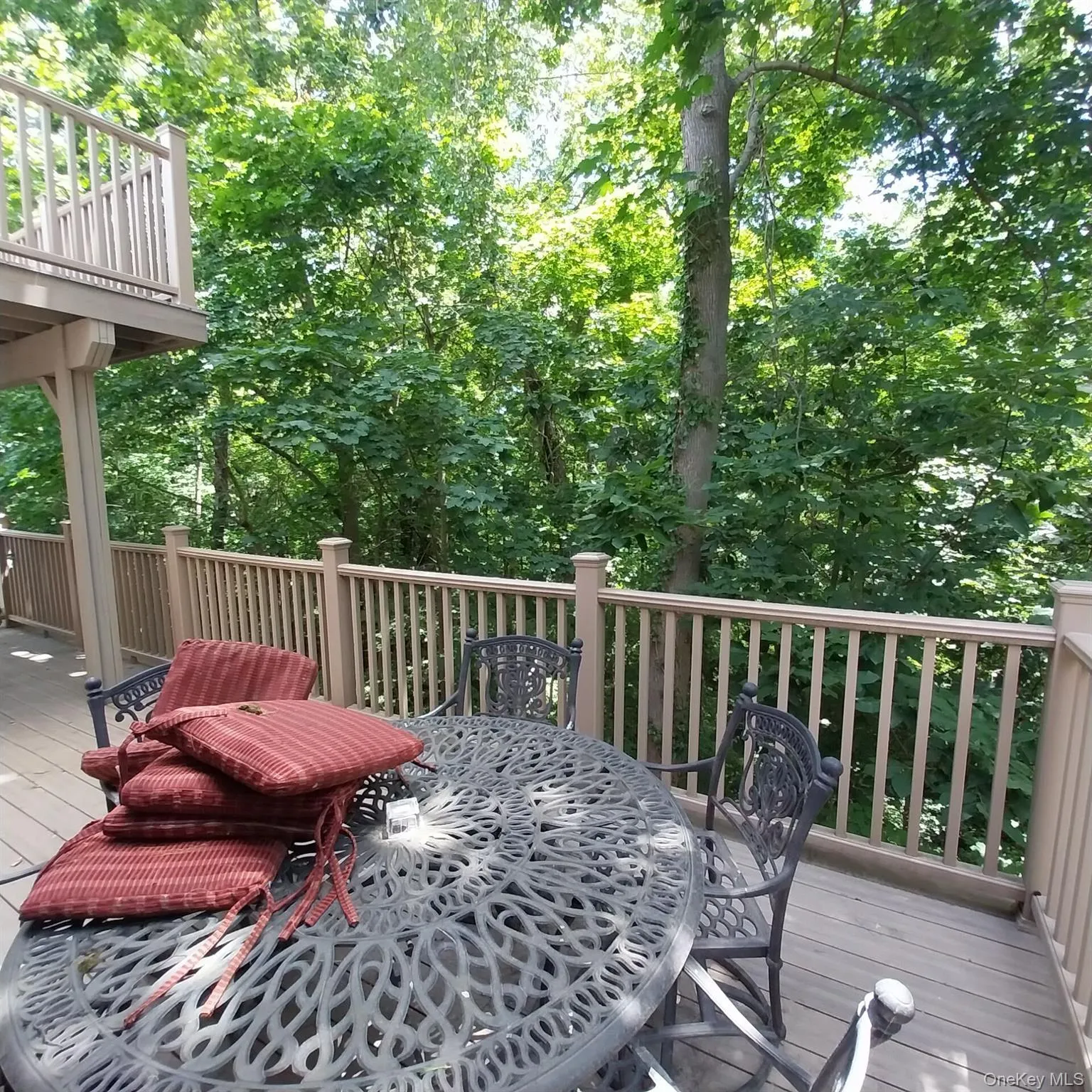 Expansive deck with wood-finish flooring and a full railing system Expansive deck with wood-finish flooring and a full railing system