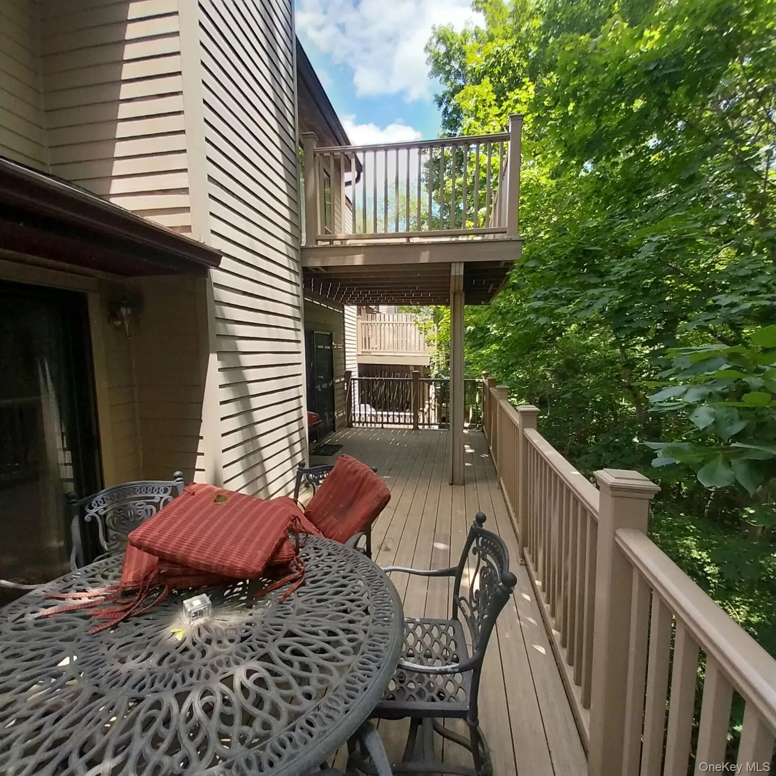 Spacious outdoor deck featuring wood-finish flooring, a full railing system, and direct exterior access Spacious outdoor deck featuring wood-finish flooring, a full railing system, and direct exterior access