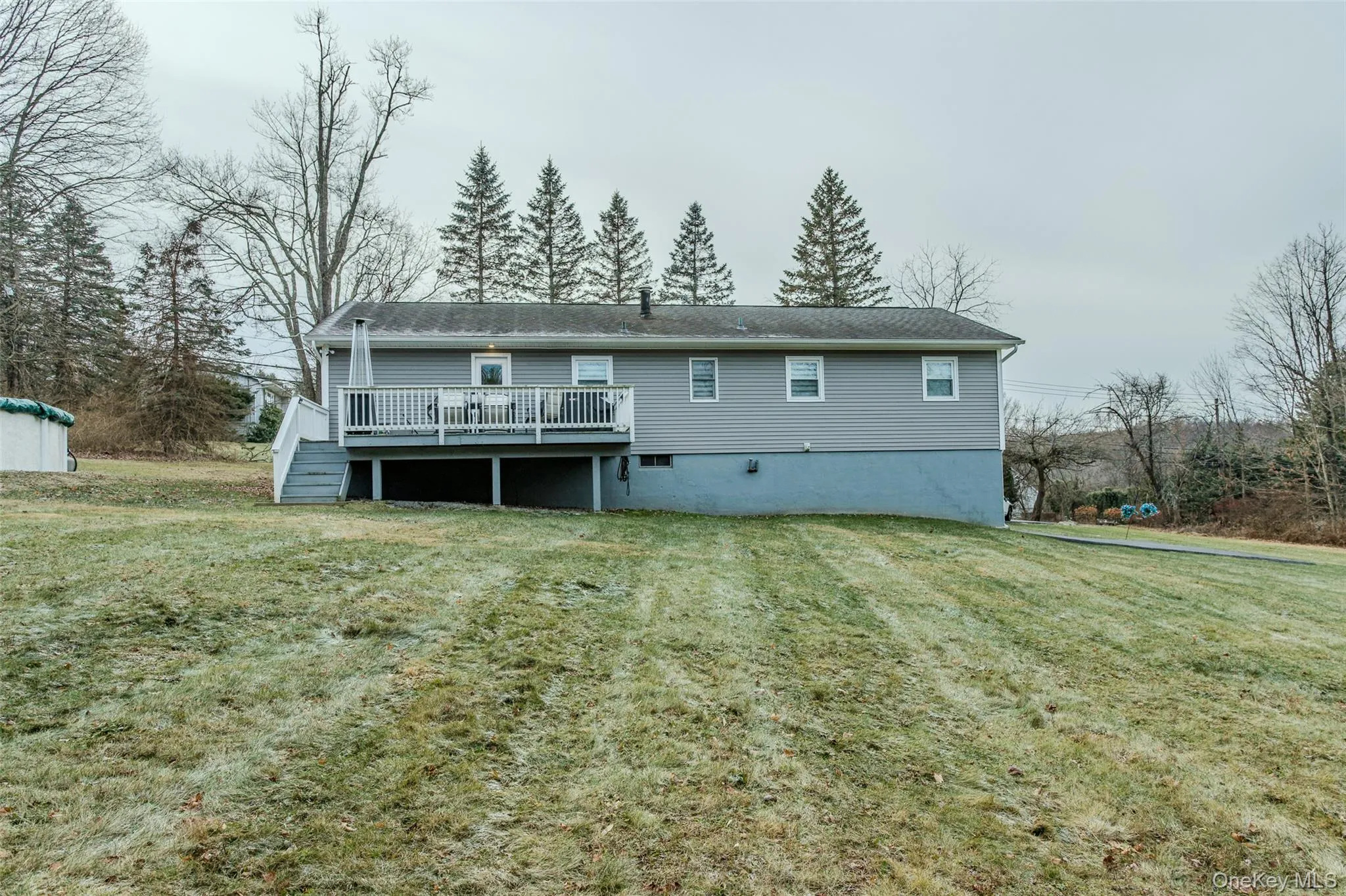 Rear view of property with a lawn and a deck Rear view of property with a lawn and a deck