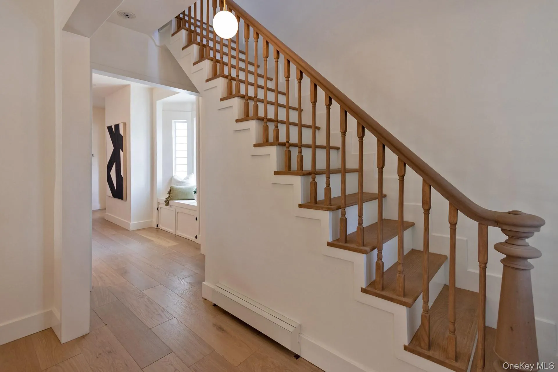 Traditional wood staircase with turned balusters and a decorative newel post Traditional wood staircase with turned balusters and a decorative newel post