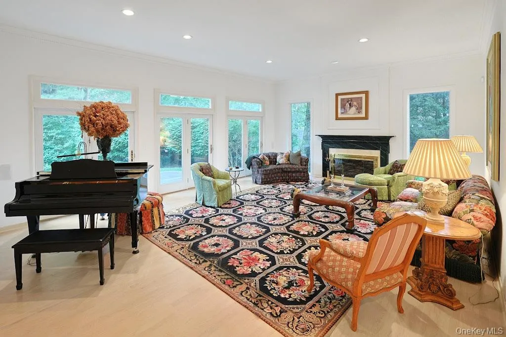 Grand living room with fireplace and doors to property Grand living room with fireplace and doors to property