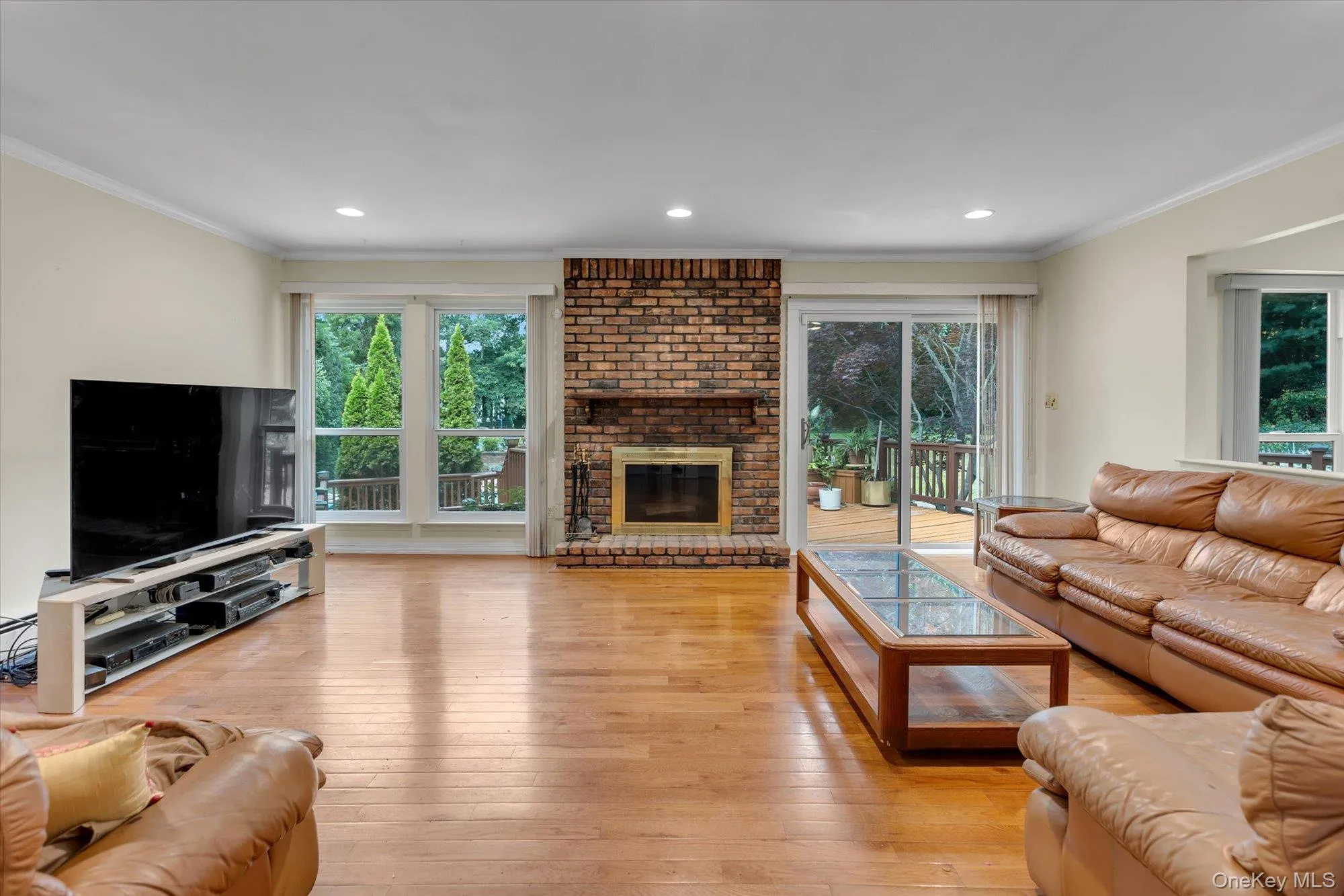 Den with wood burning fireplace and entry to backyard deck Den with wood burning fireplace and entry to backyard deck