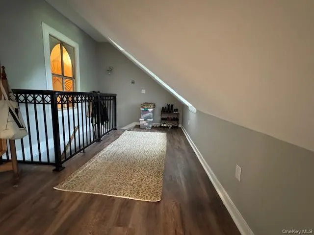 Bonus room with wood finished floors and vaulted ceiling Bonus room with wood finished floors and vaulted ceiling