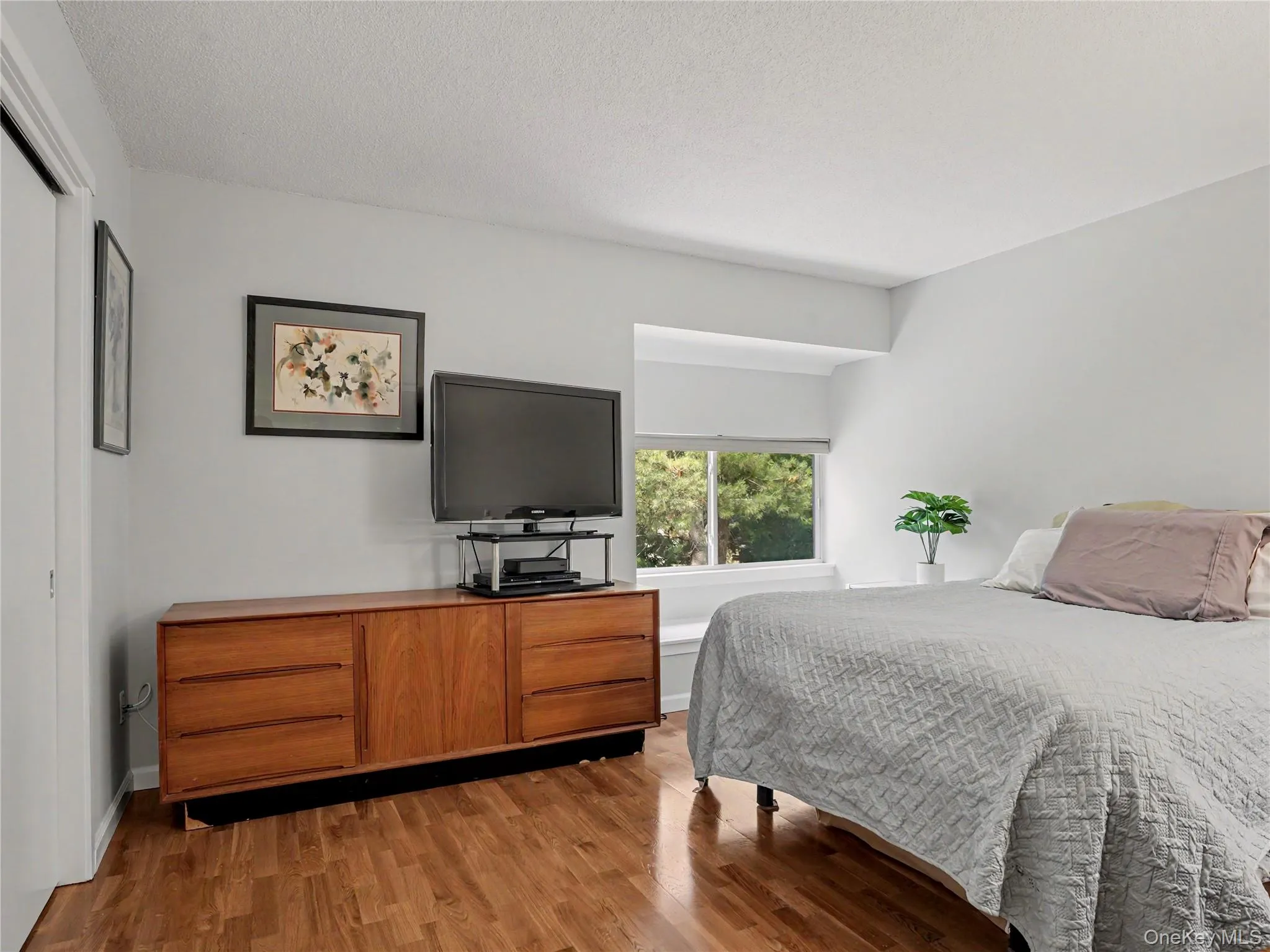 Spacious bedroom with a window seat, and spacious closet with custom-built shelving. Spacious bedroom with a window seat, and spacious closet with custom-built shelving.