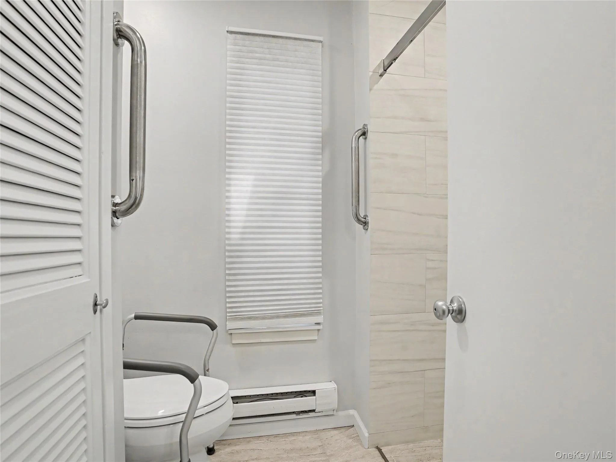 The updated bathroom features a walk-in shower with a glass door. The updated bathroom features a walk-in shower with a glass door.