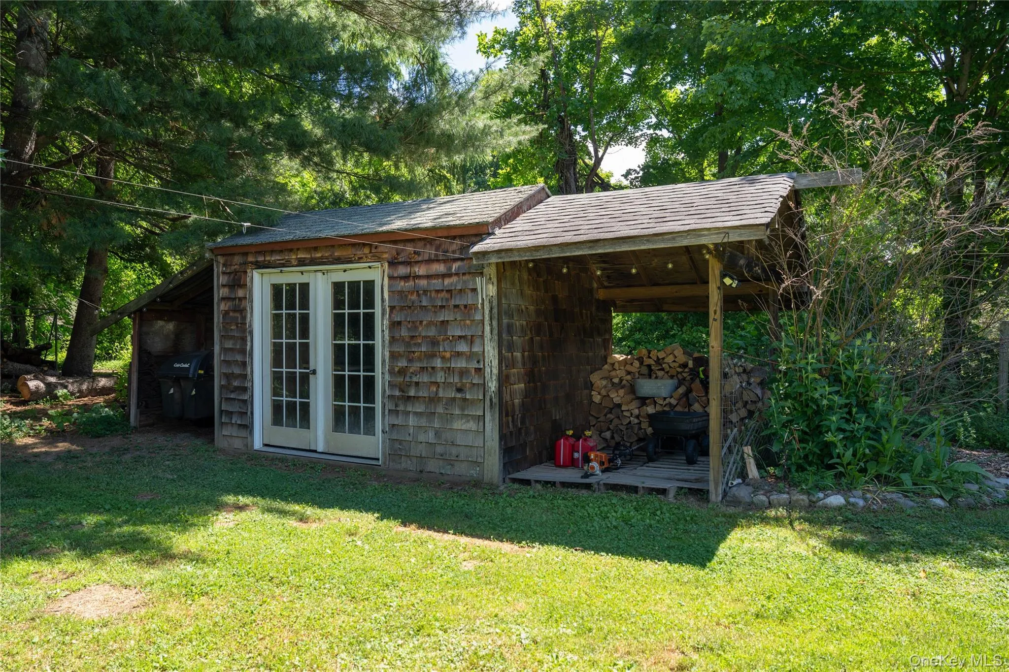 Garden shed featuring weathered wood shake siding. Garden shed featuring weathered wood shake siding.