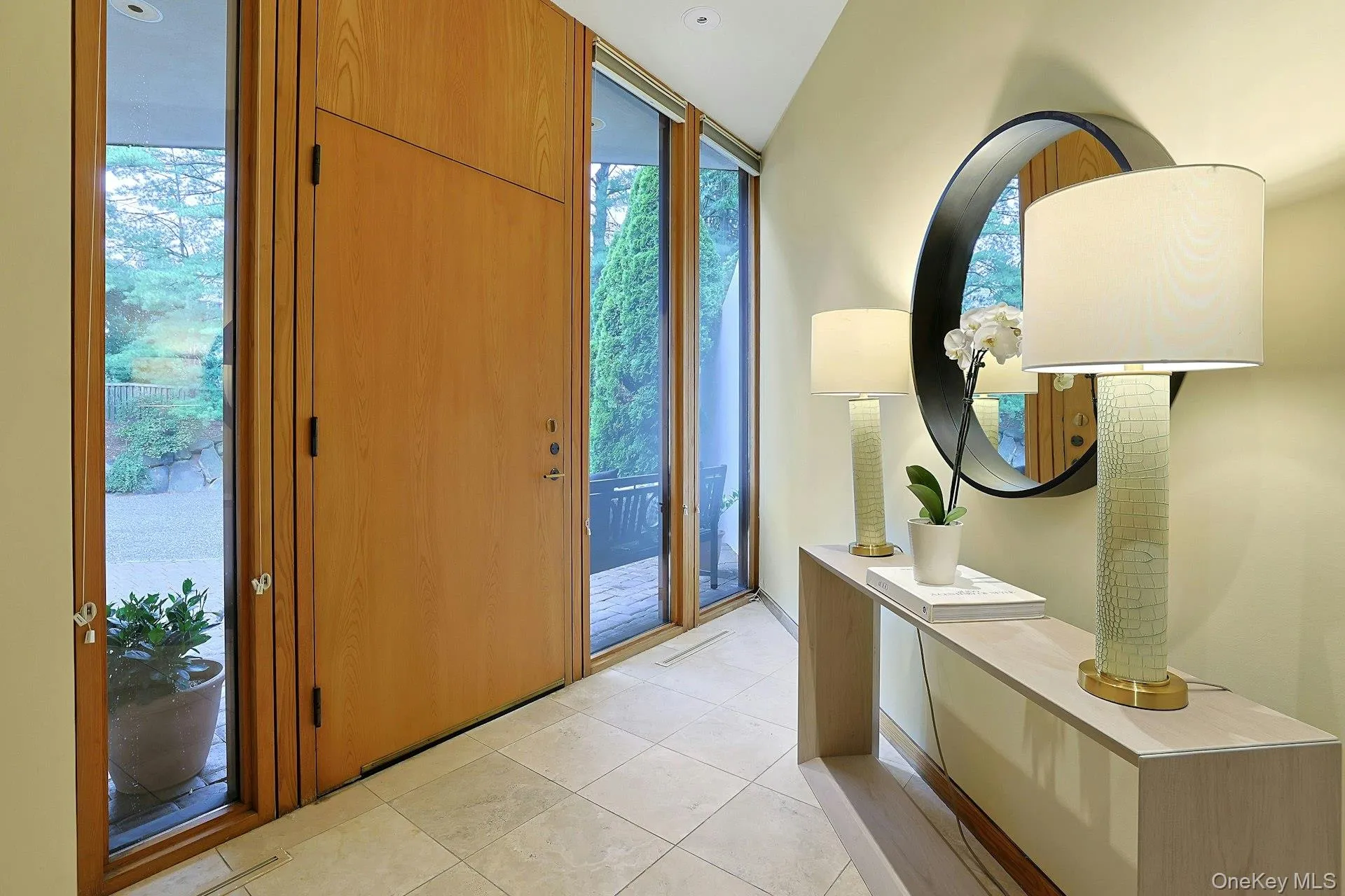 Sunlight pours through floor-to-ceiling glass in the welcoming foyer, offering a glimpse of the extraordinary spaces beyond. Sunlight pours through floor-to-ceiling glass in the welcoming foyer, offering a glimpse of the extraordinary spaces beyond.