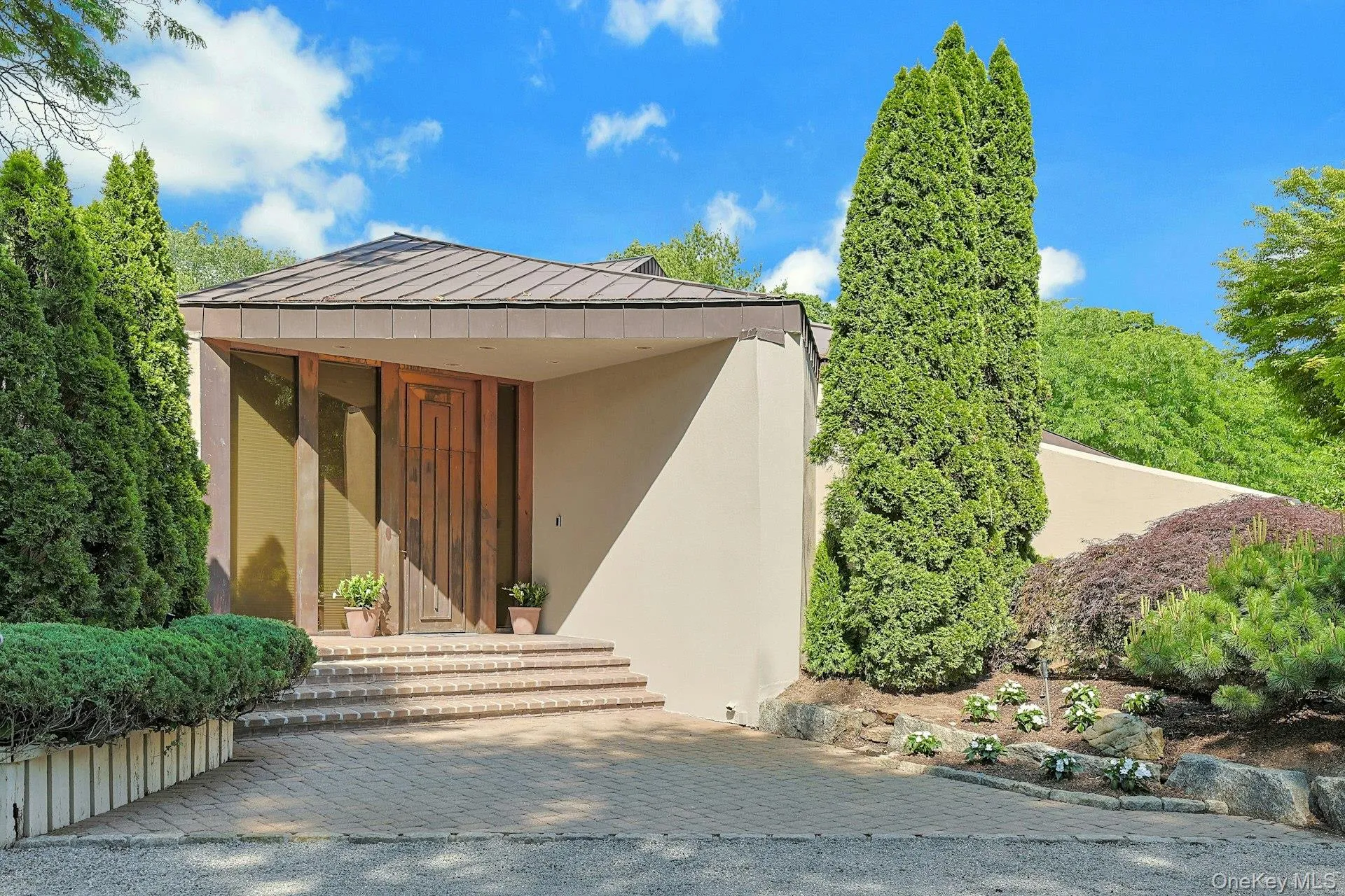 A dramatic copper entry door and striking architectural lines create a memorable first impression upon arrival. A dramatic copper entry door and striking architectural lines create a memorable first impression upon arrival.