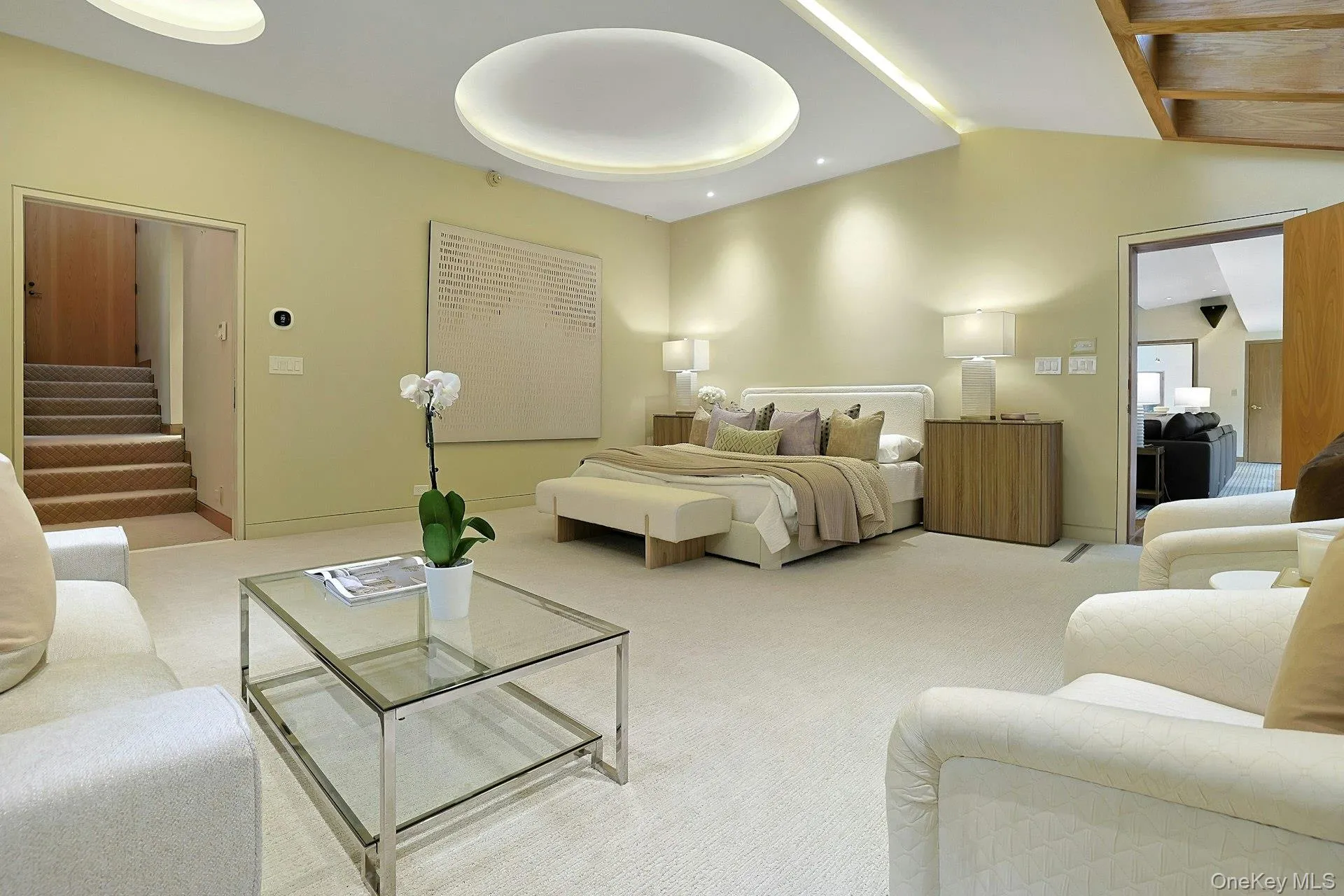 The expansive primary suite offers exceptional scale with room for multiple seating areas and a true sanctuary-like atmosphere. The expansive primary suite offers exceptional scale with room for multiple seating areas and a true sanctuary-like atmosphere.