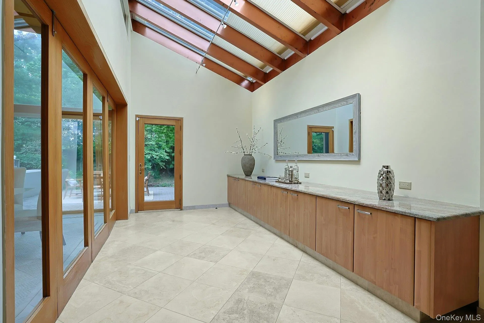 A skylit Butler's Pantry connects the kitchen, dining room and patio, showcasing the home's clean architectural lines and abundant natural light. A skylit Butler's Pantry connects the kitchen, dining room and patio, showcasing the home's clean architectural lines and abundant natural light.