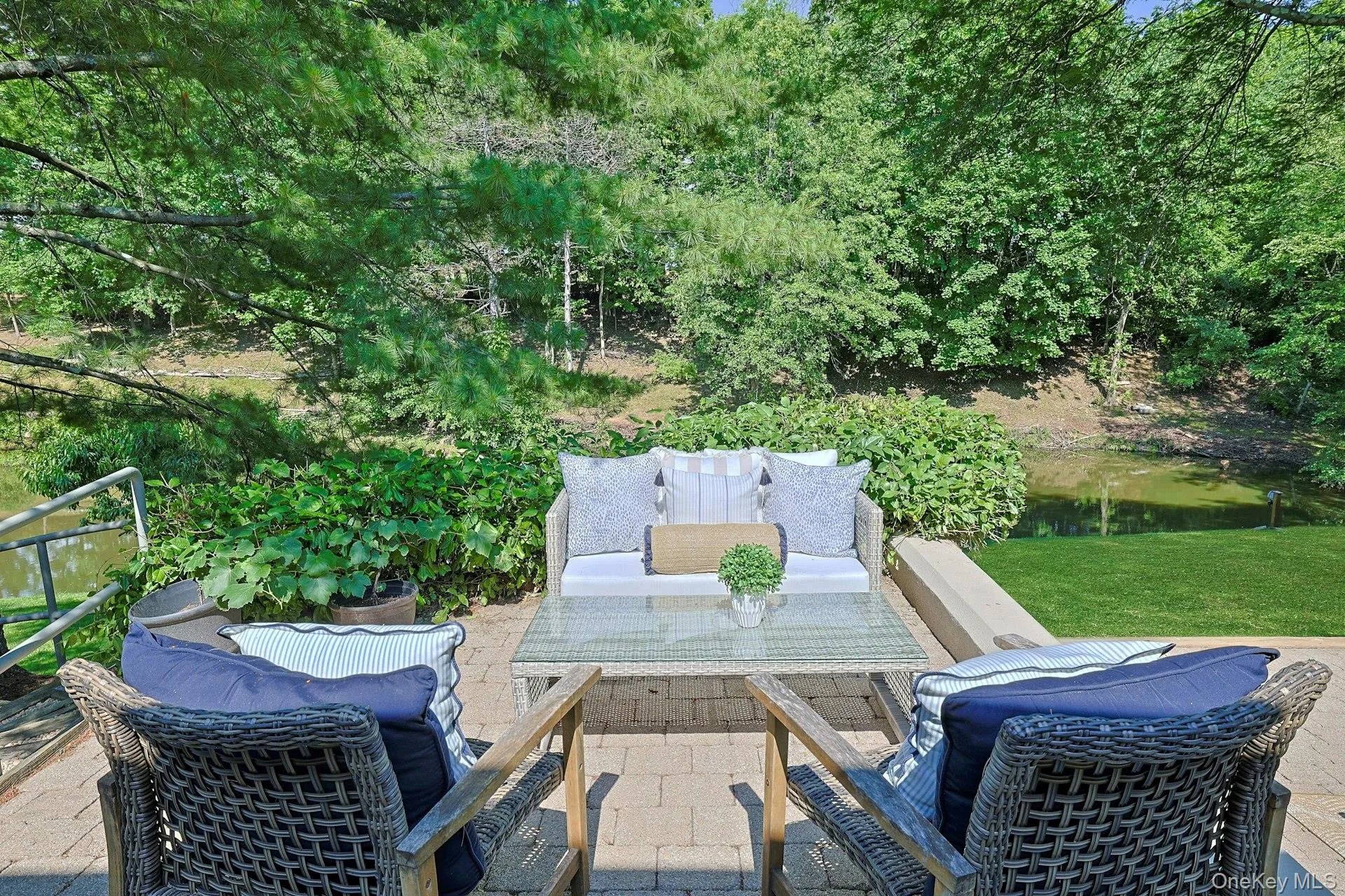 An elevated terrace off of the living room and overlooking the pond offers the perfect place to unwind and enjoy the peaceful setting. An elevated terrace off of the living room and overlooking the pond offers the perfect place to unwind and enjoy the peaceful setting.
