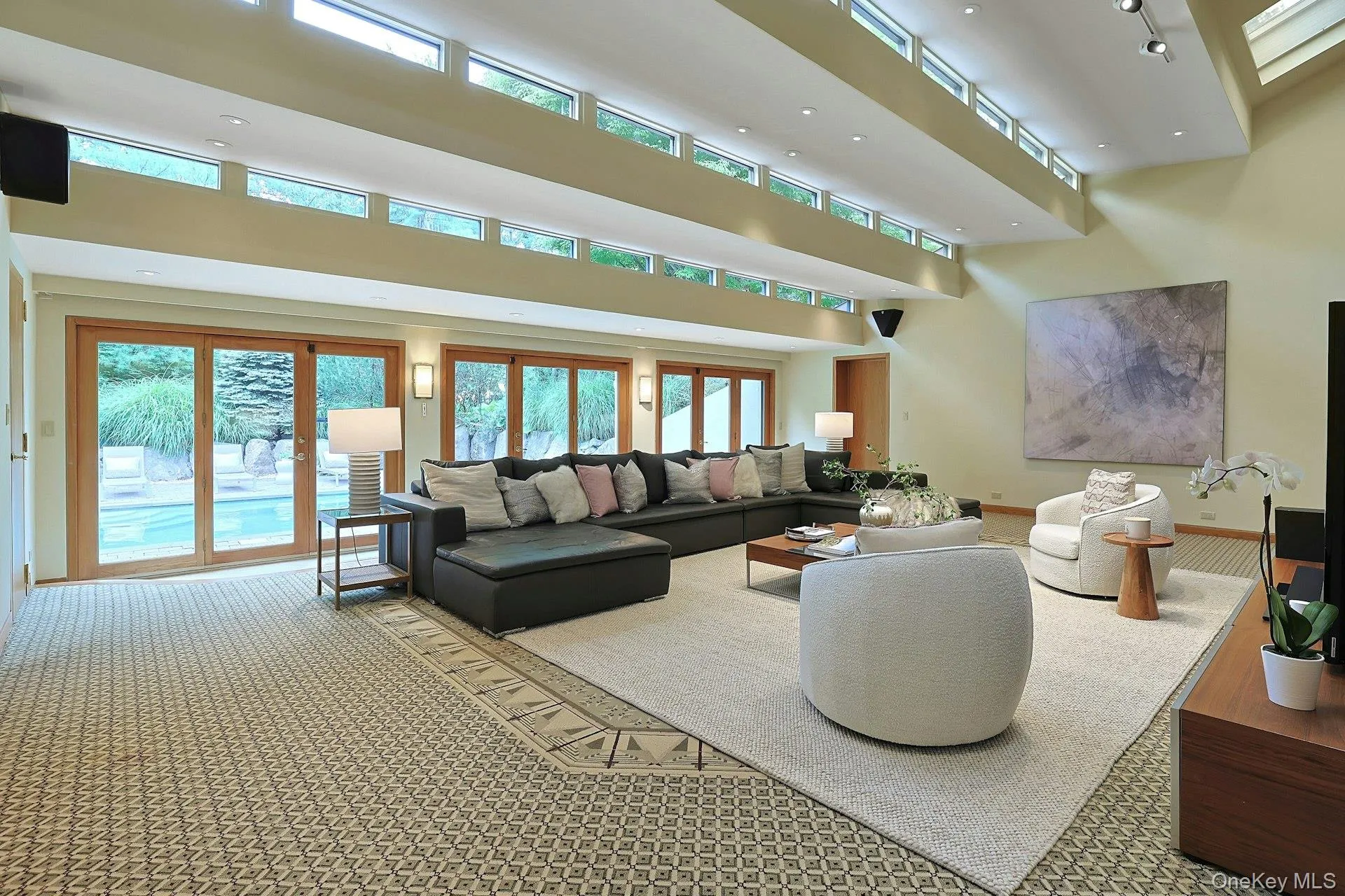 Designed for both grand entertaining and everyday comfort, this expansive gathering space is filled with natural light and serene views Designed for both grand entertaining and everyday comfort, this expansive gathering space is filled with natural light and serene views