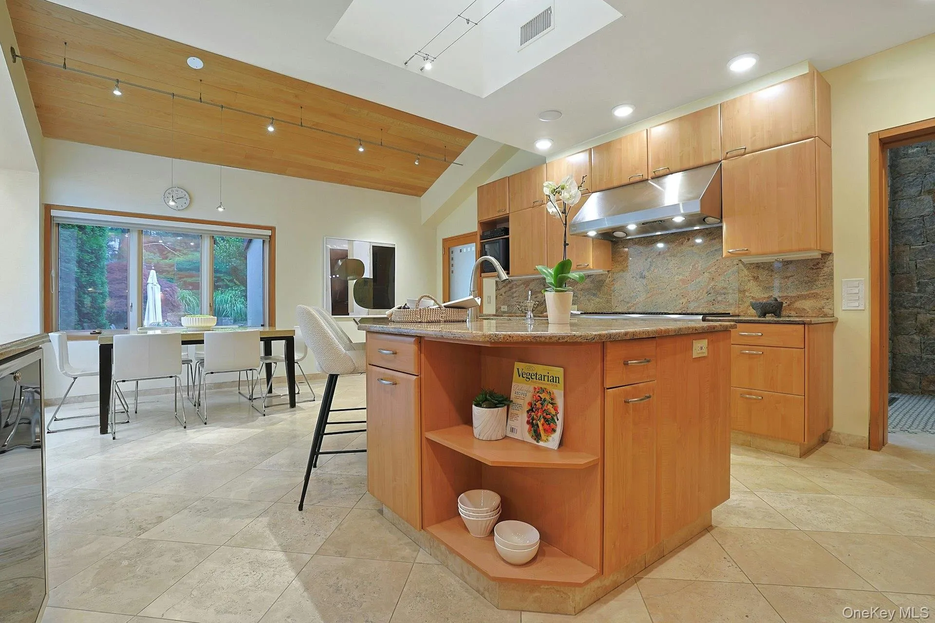 An oversized island anchors the space while skylights above bathe the kitchen in natural sunlight throughout the day. An oversized island anchors the space while skylights above bathe the kitchen in natural sunlight throughout the day.