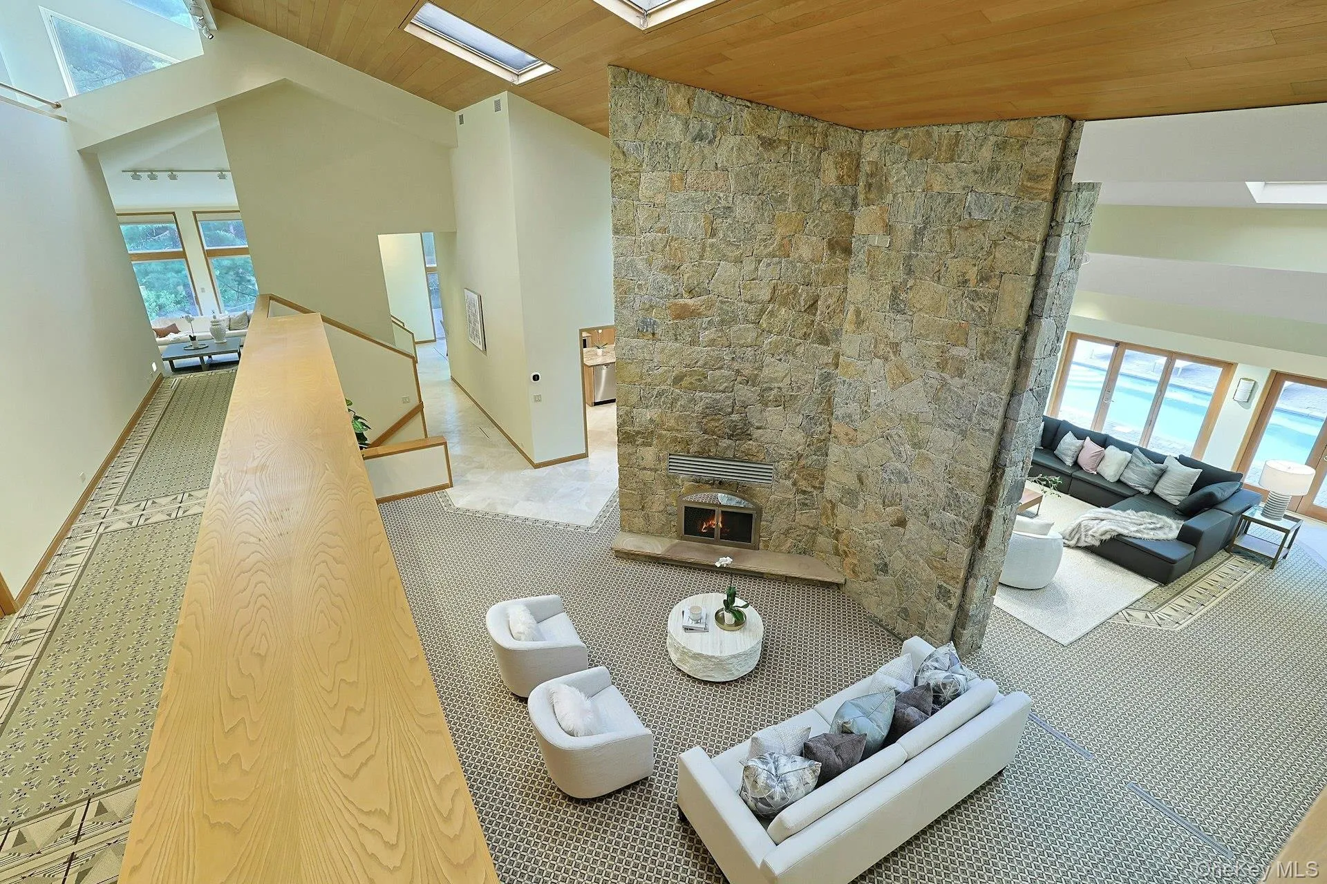 A stunning fieldstone fireplace rises dramatically through the heart of the home, anchoring multiple living areas. A stunning fieldstone fireplace rises dramatically through the heart of the home, anchoring multiple living areas.