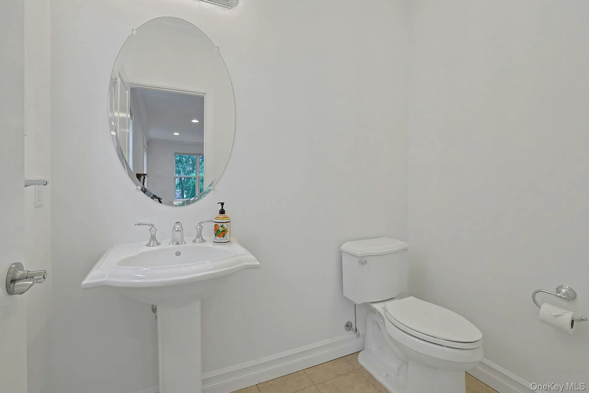 Conveniently located on the main level, this bright powder room offers classic finishes and easy access for both residents and guests. Conveniently located on the main level, this bright powder room offers classic finishes and easy access for both residents and guests.