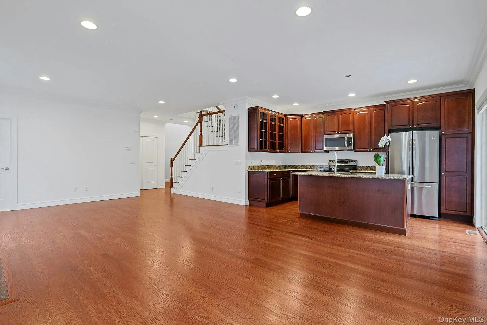 Well-appointed with rich wood cabinetry, granite countertops, stainless steel appliances, and a center island with seating. Well-appointed with rich wood cabinetry, granite countertops, stainless steel appliances, and a center island with seating.