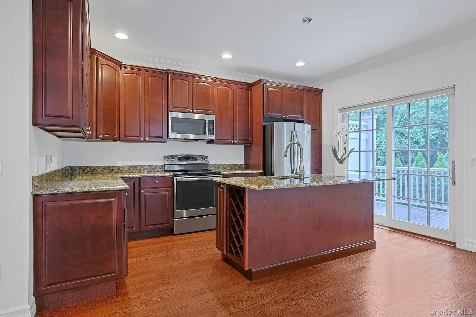 The granite island serves as the heart of the kitchen, offering seating, prep space, and additional storage. The granite island serves as the heart of the kitchen, offering seating, prep space, and additional storage.