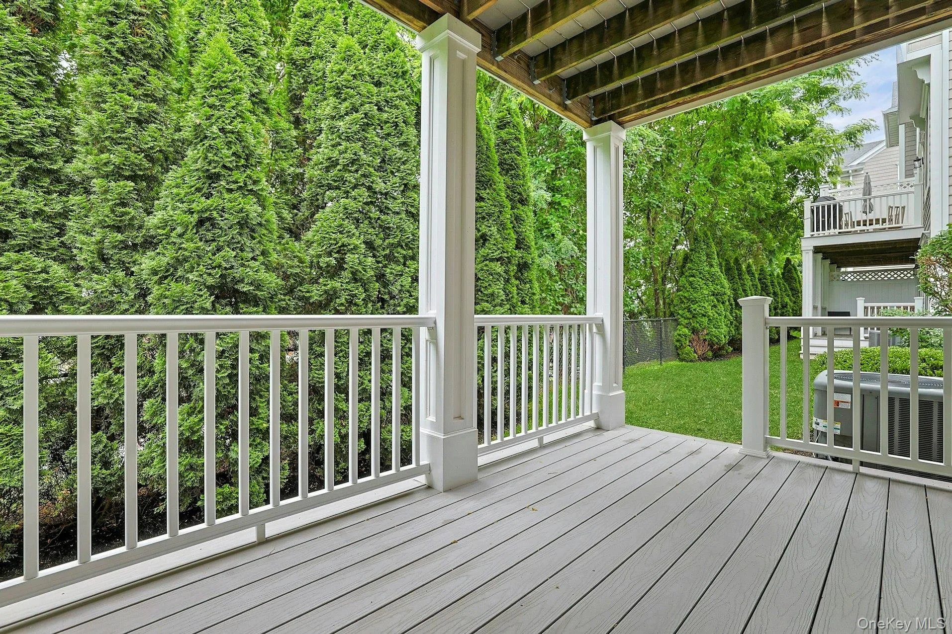 Enjoy morning coffee or evening relaxation on the covered deck overlooking mature landscaping and lush greenery, offering a peaceful extension of the home's living space. Enjoy morning coffee or evening relaxation on the covered deck overlooking mature landscaping and lush greenery, offering a peaceful extension of the home's living space.