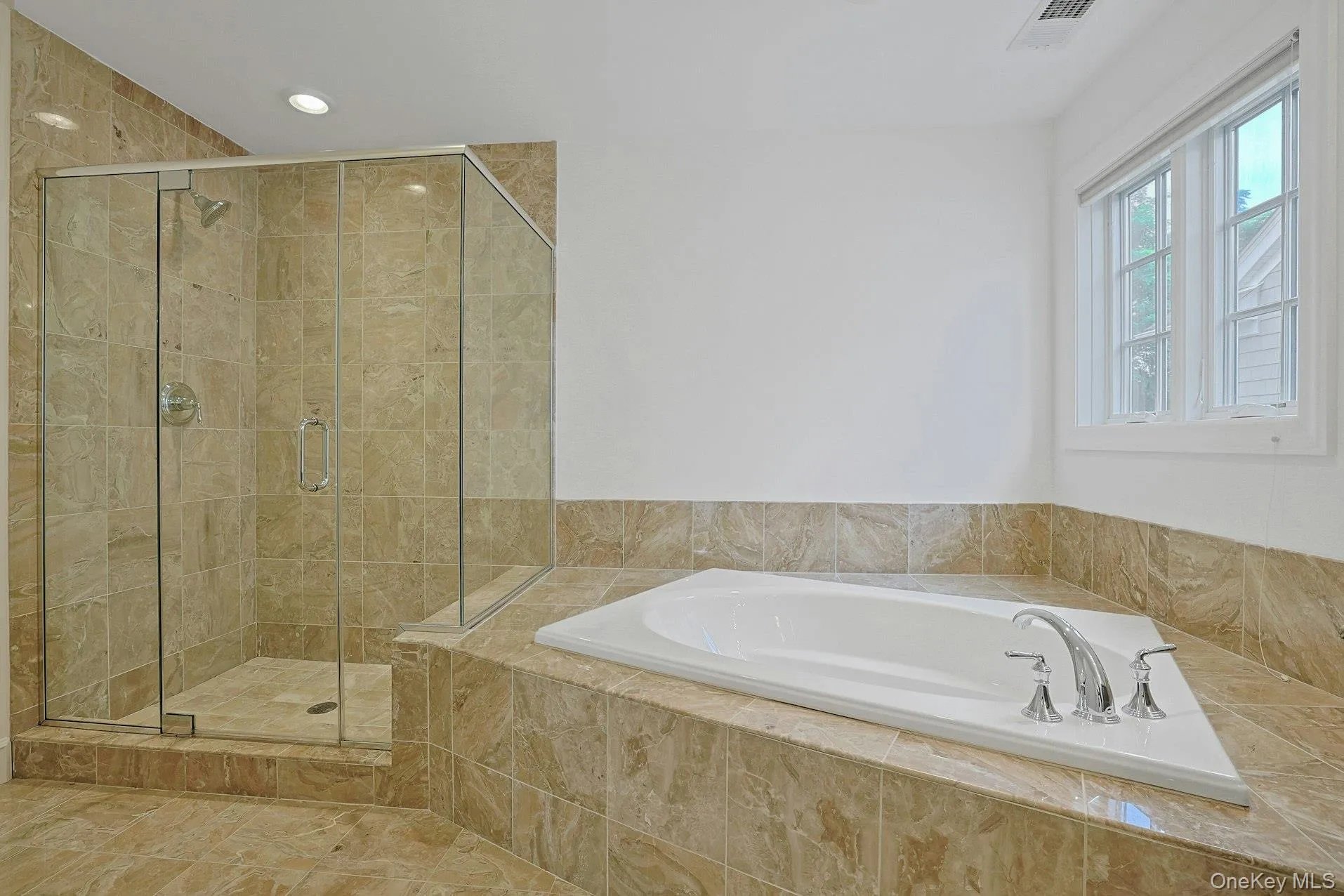 Unwind in the oversized soaking tub or enjoy the separate glass-enclosed shower, creating a true retreat for everyday living. Unwind in the oversized soaking tub or enjoy the separate glass-enclosed shower, creating a true retreat for everyday living.