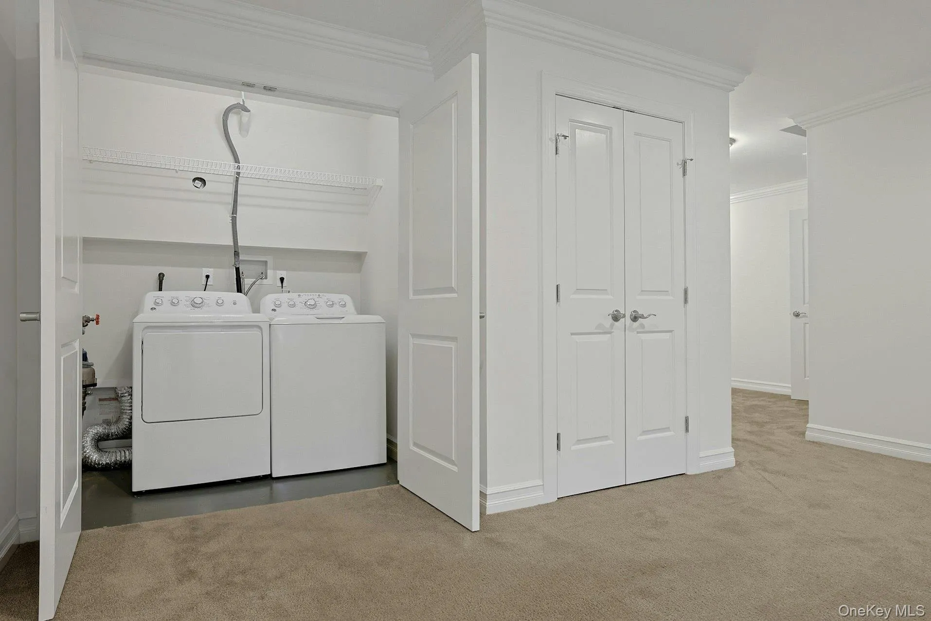 Conveniently located on the lower level, the dedicated laundry area accommodates a full-size washer and dryer and offers practical storage space for household essentials. Conveniently located on the lower level, the dedicated laundry area accommodates a full-size washer and dryer and offers practical storage space for household essentials.