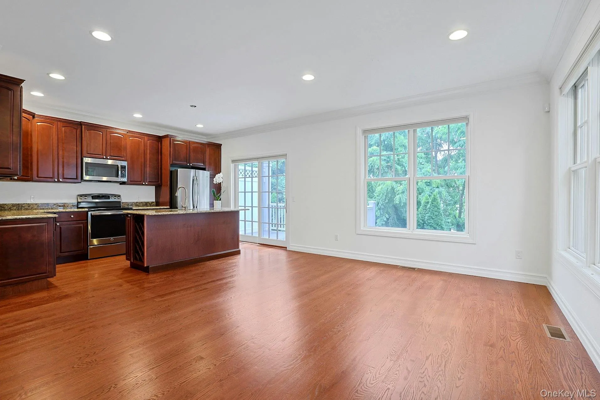 Well-appointed with rich wood cabinetry, granite countertops, stainless steel appliances, and a center island with seating. Well-appointed with rich wood cabinetry, granite countertops, stainless steel appliances, and a center island with seating.