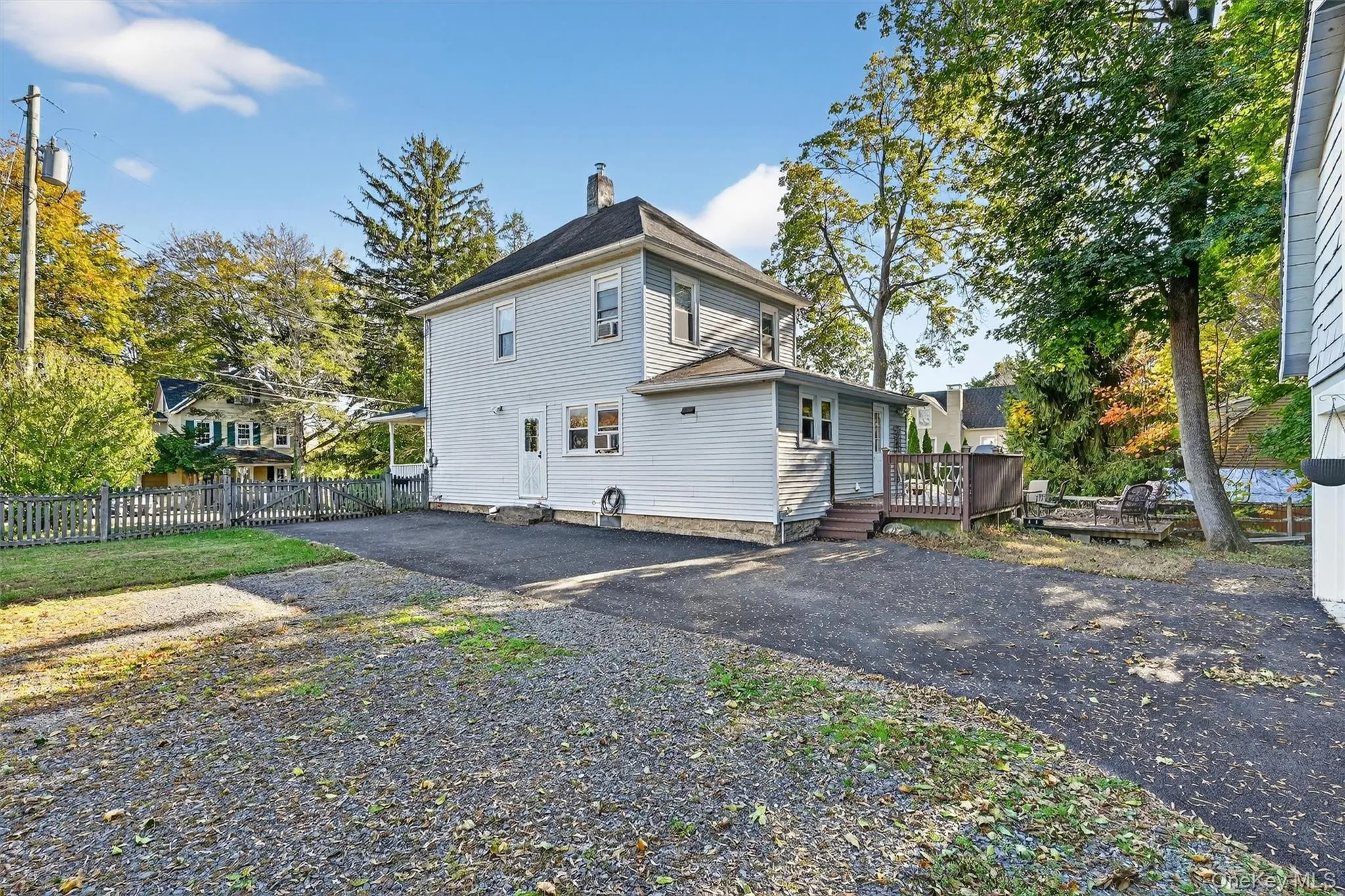 Spacious rear driveway with ample parking and access to the side entry. The backyard offers a deck, mature trees, and a peaceful outdoor area for relaxing or entertaining. Spacious rear driveway with ample parking and access to the side entry. The backyard offers a deck, mature trees, and a peaceful outdoor area for relaxing or entertaining.